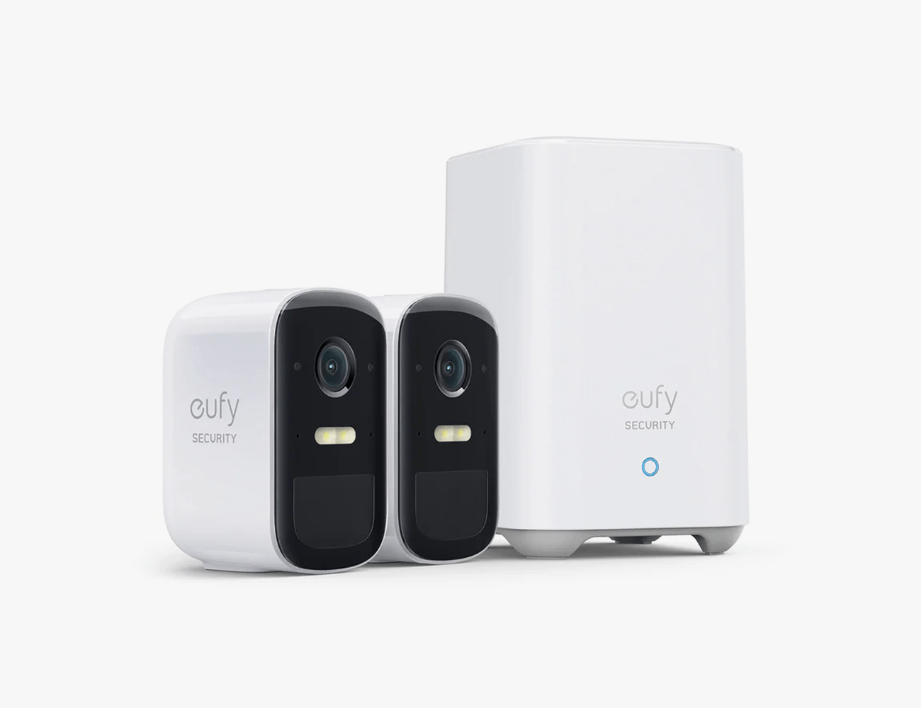 2 white and black home security cameras next to a white base