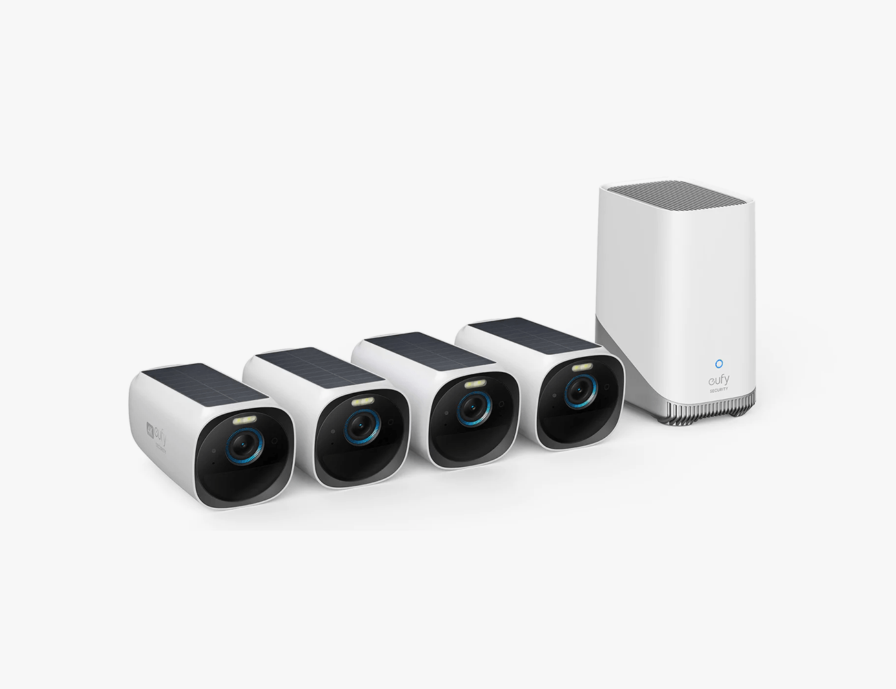 4 home security cameras with a large white base next to them