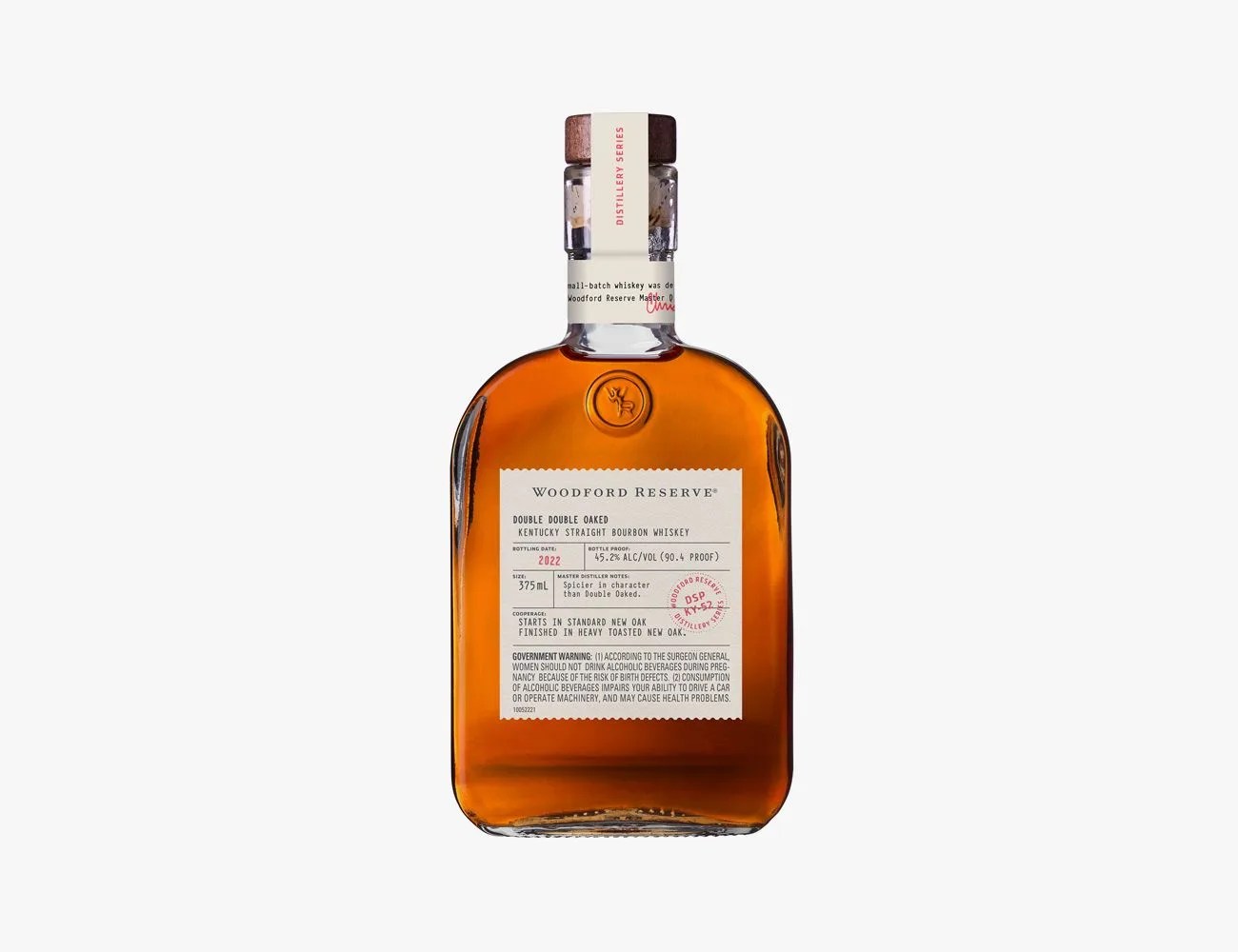 a glass bottle with brown liquor and a white label