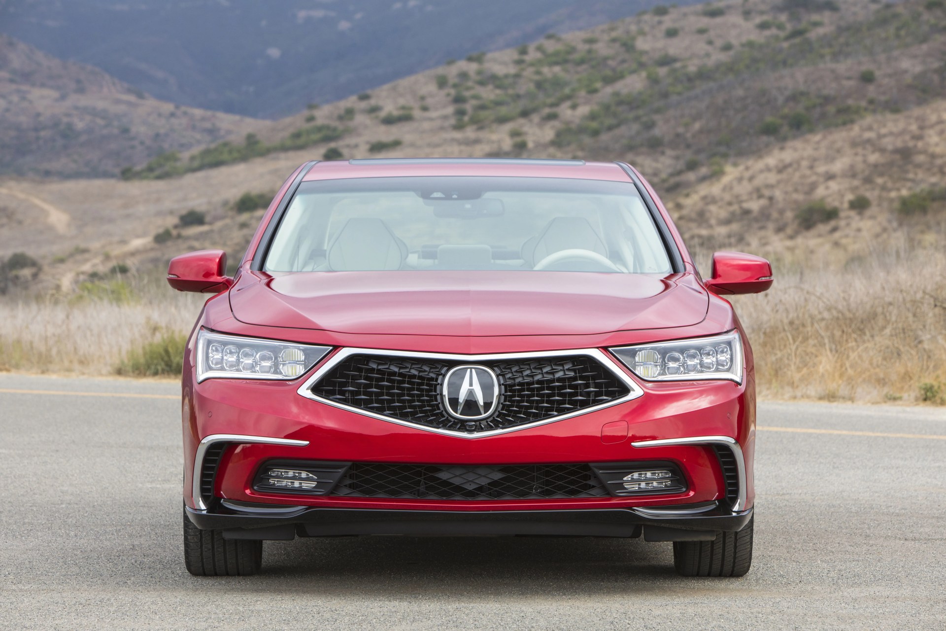 2019 acura rlx sport hybrid parked by a mountain road