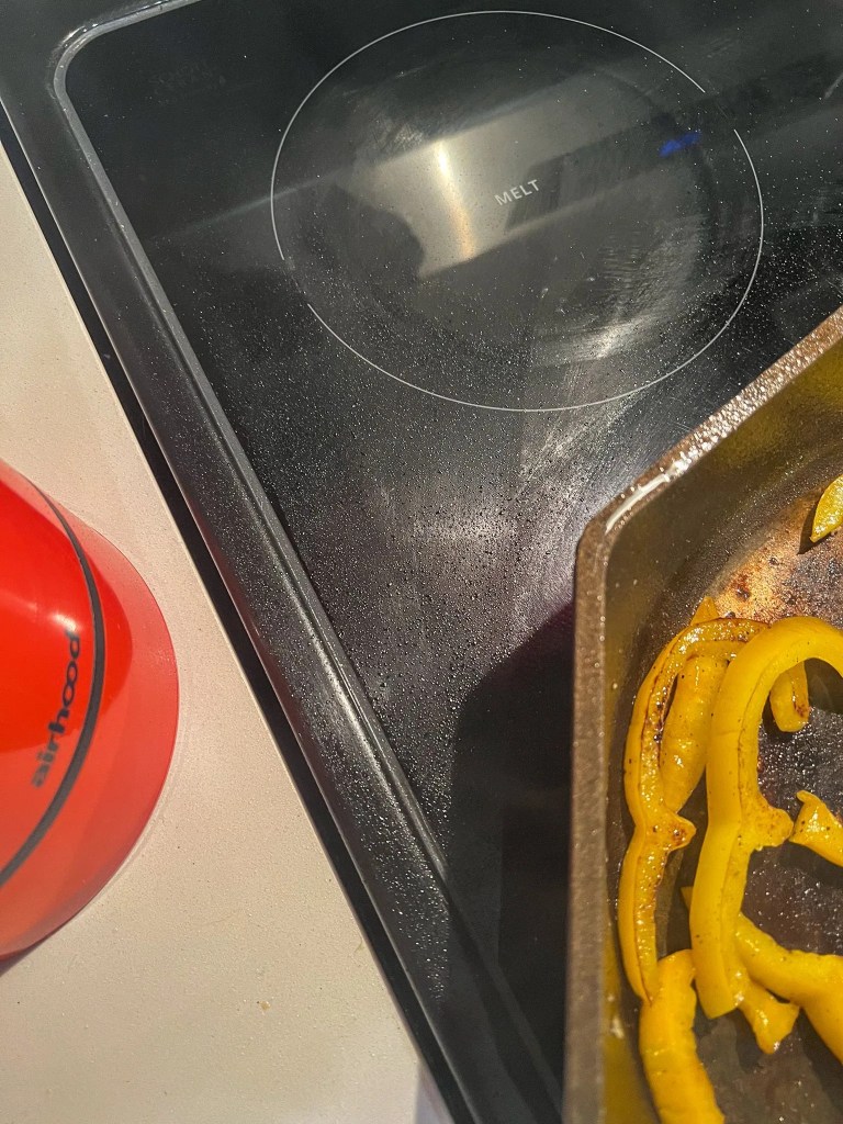 airhood vent on a countertop next to an oily stove