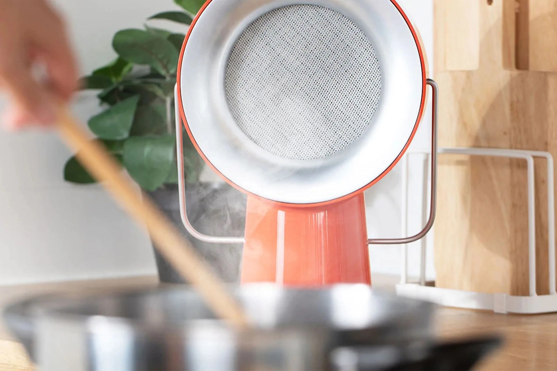 airhood vent on a countertop next to a pan cooking