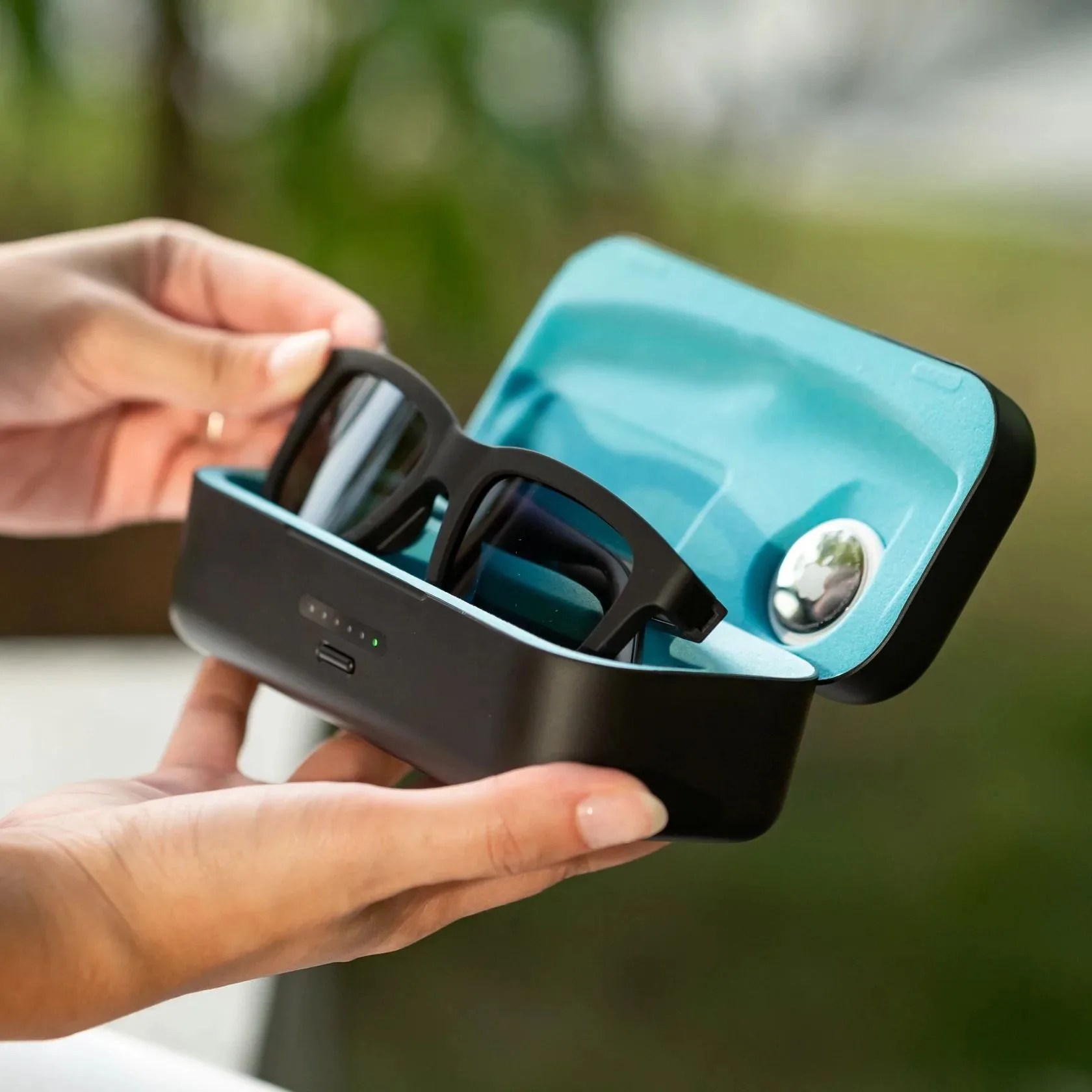 a woman holding ampere dusk sunglasses in a case