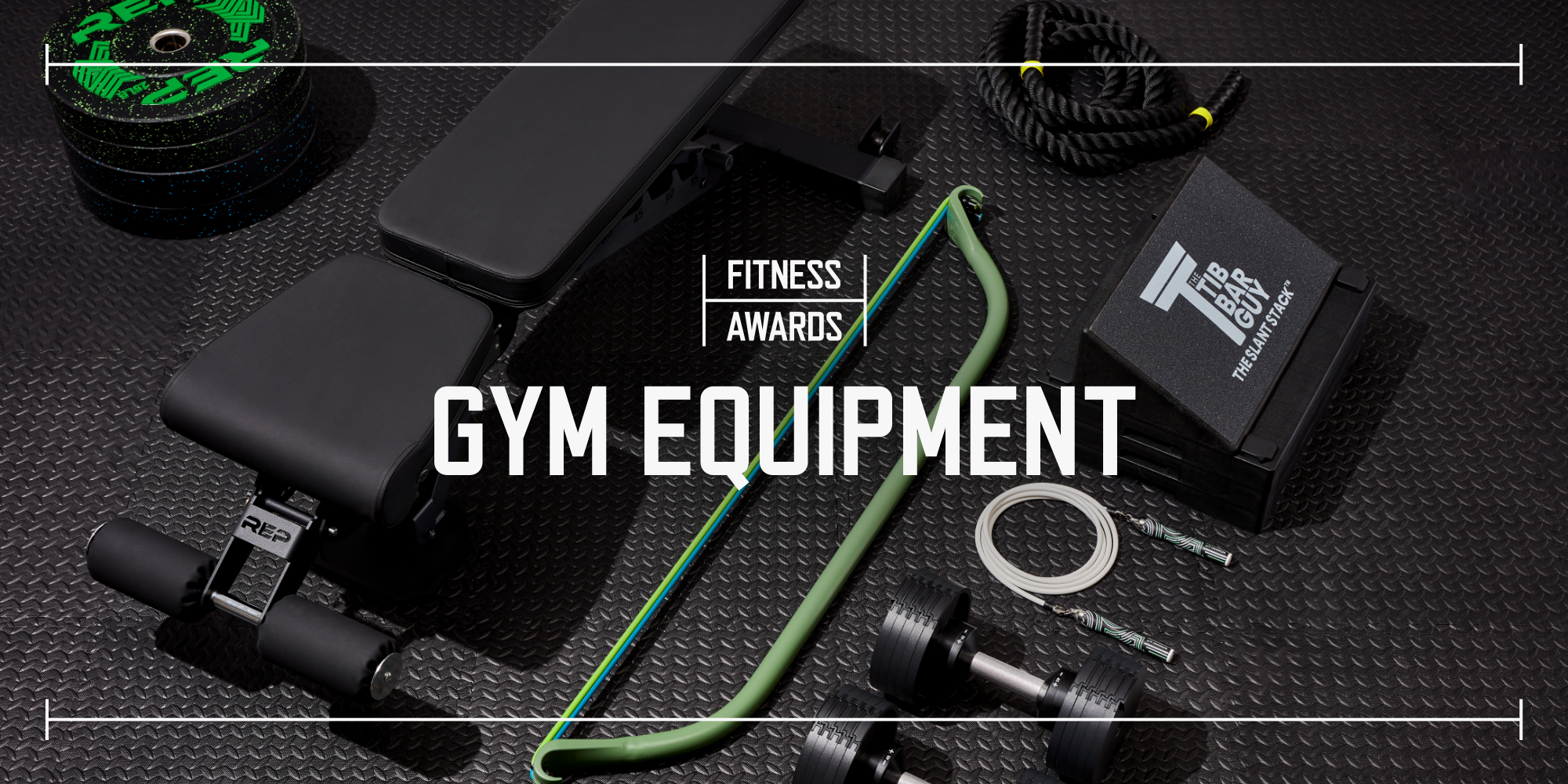 multiple pieces of gym equipment laid out on black rubber gym flooring with the text saying fitness awards gym equipment laid over top the image