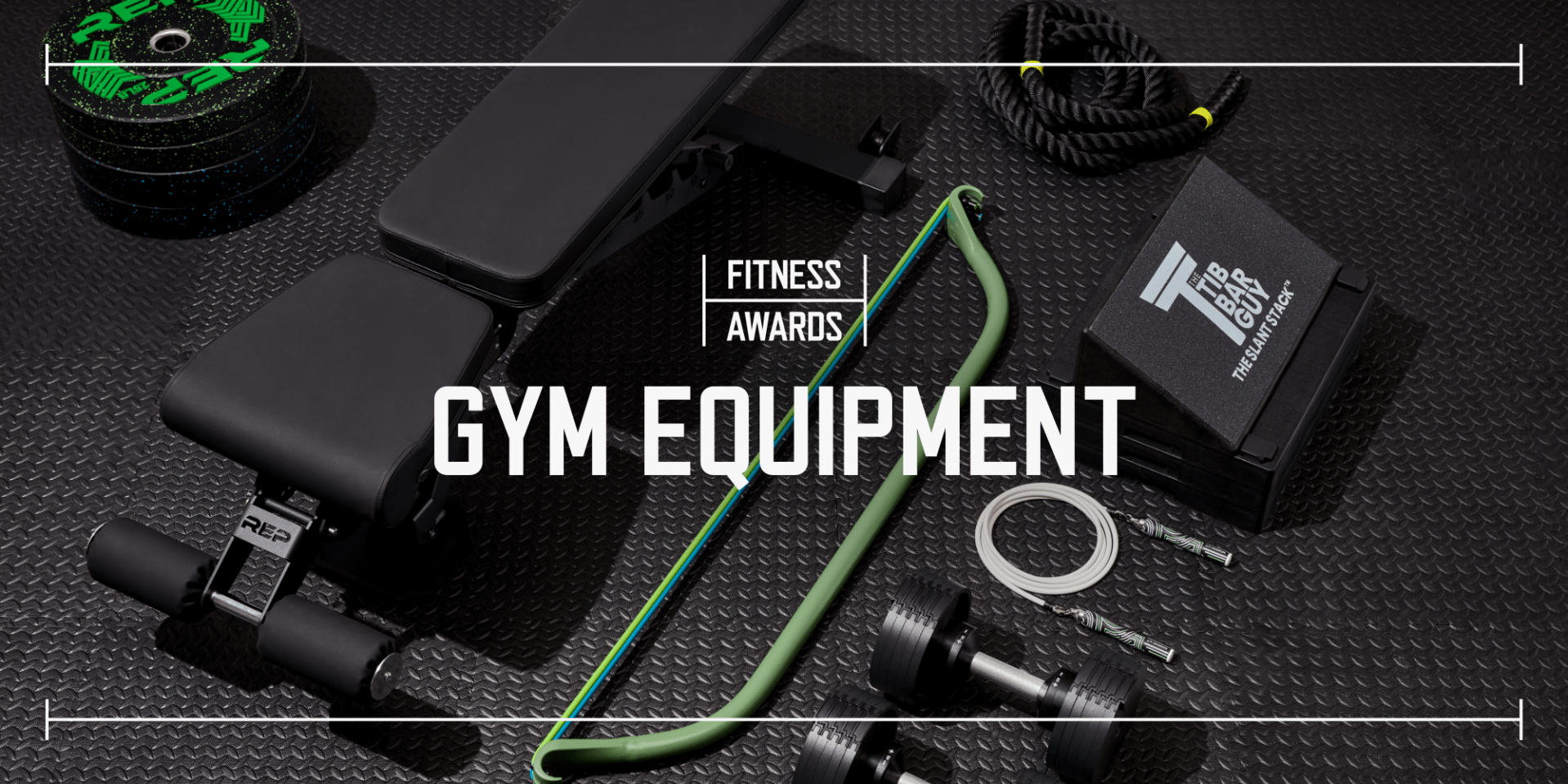 multiple pieces of gym equipment laid out on black rubber gym flooring with the text saying fitness awards gym equipment laid over top the image