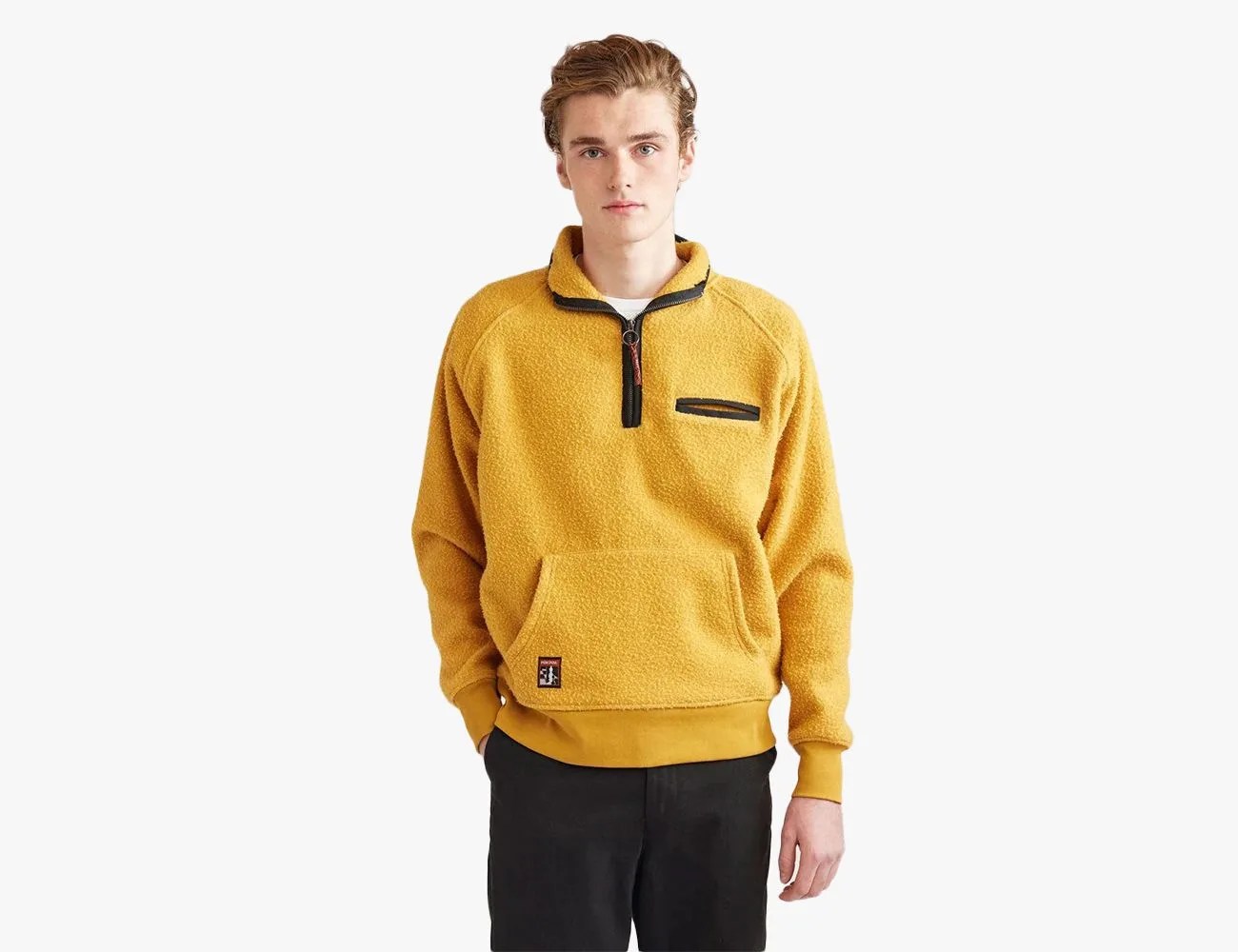 man wearing a yellow half zip fleece
