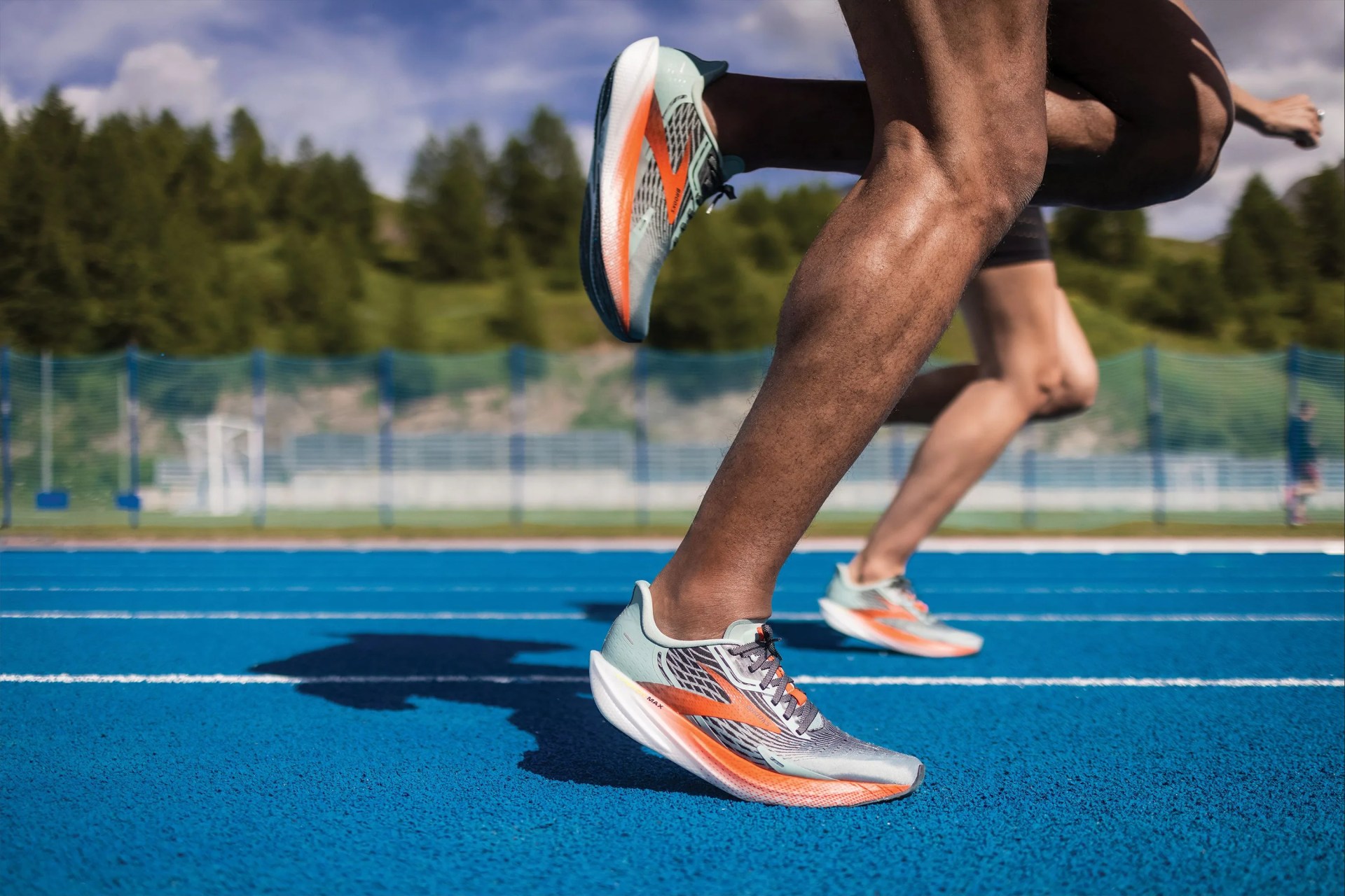 brooks running shoes with athletes on track