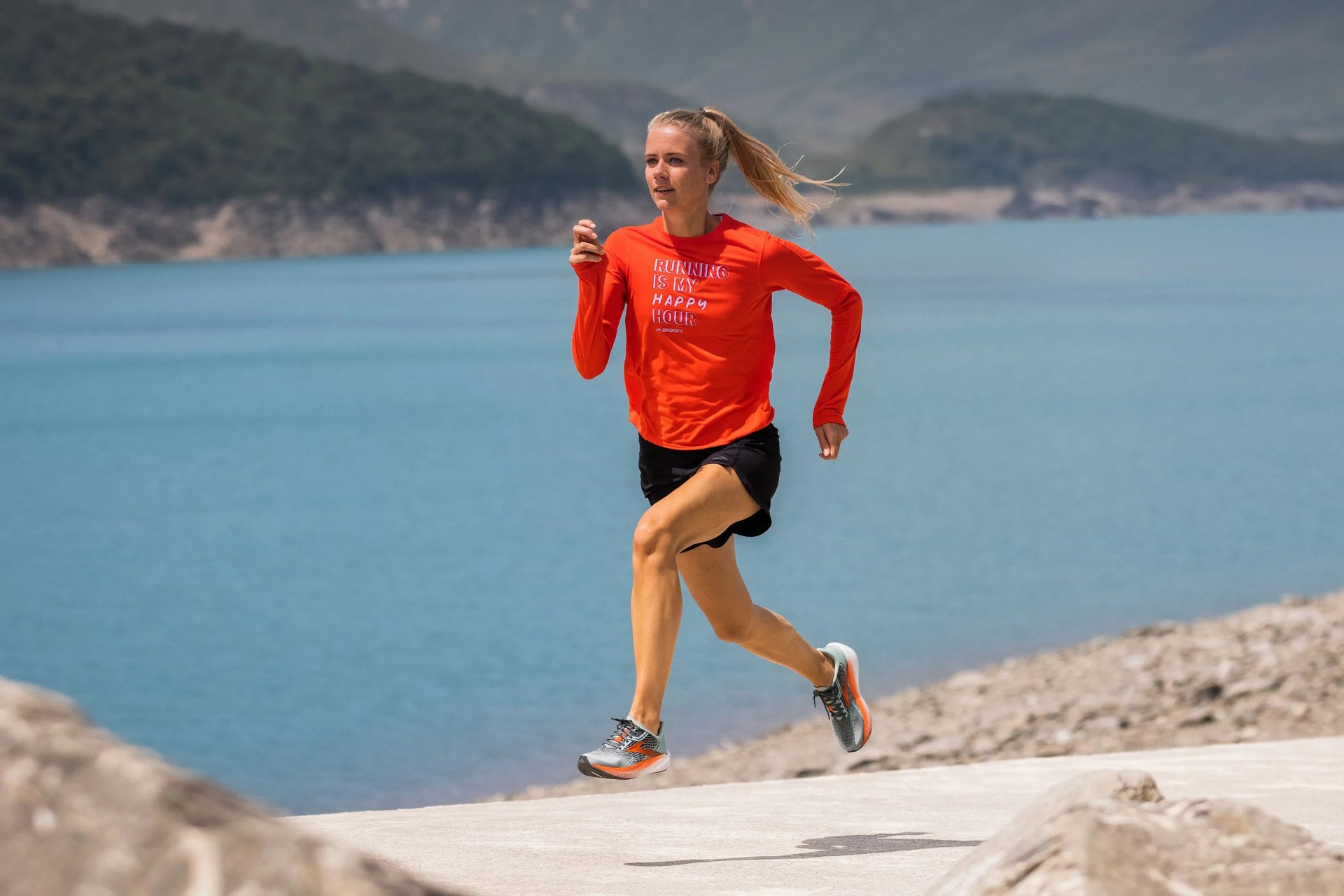 a woman running on a trail by a lake