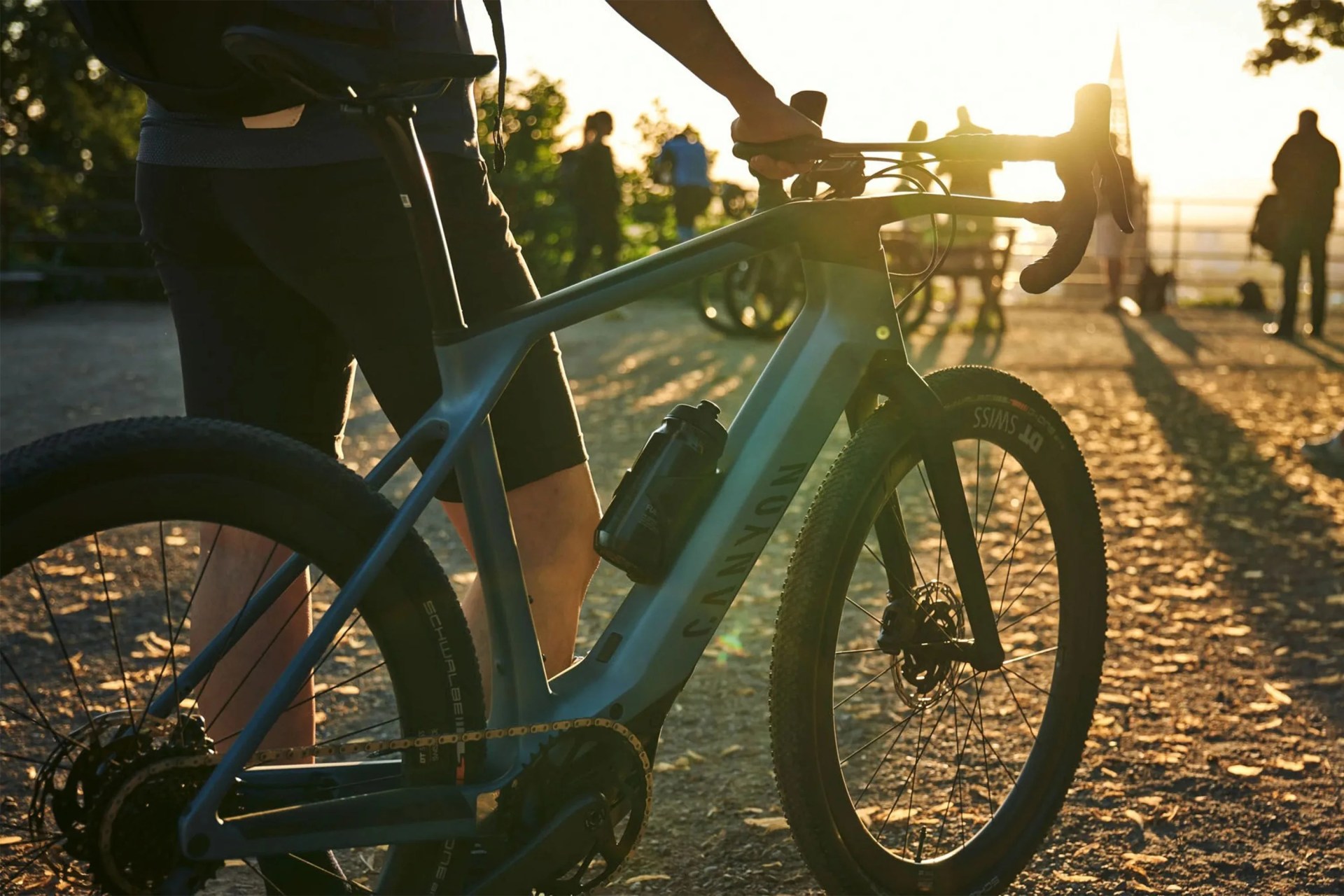 a person standing next to a gravel bike