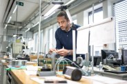 aaron rodgers at the zenith workshop looking at watch pieces
