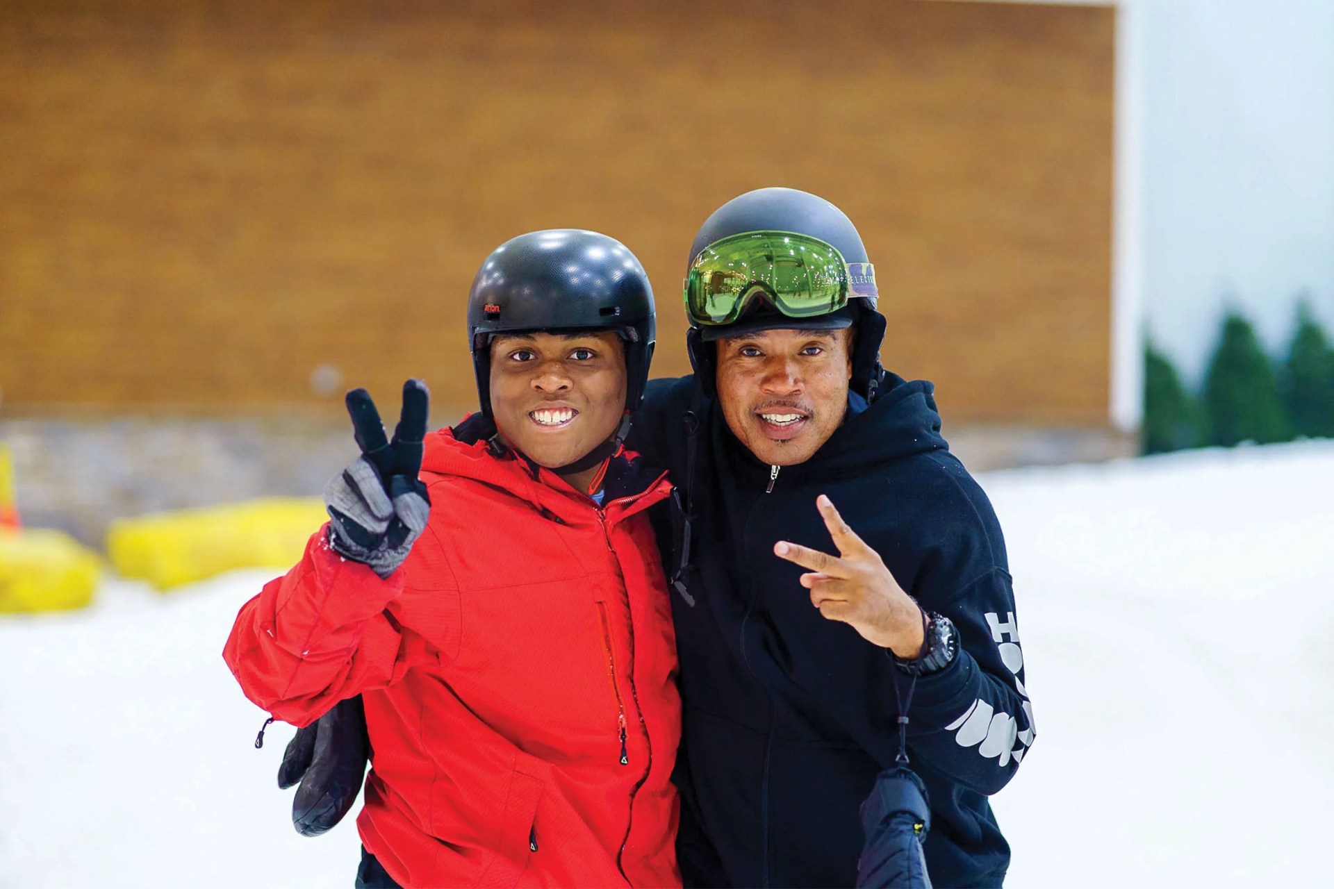 daniel ransford green and
paupaw who cofounded hoods to
woods smiling for the camera with peace signs
