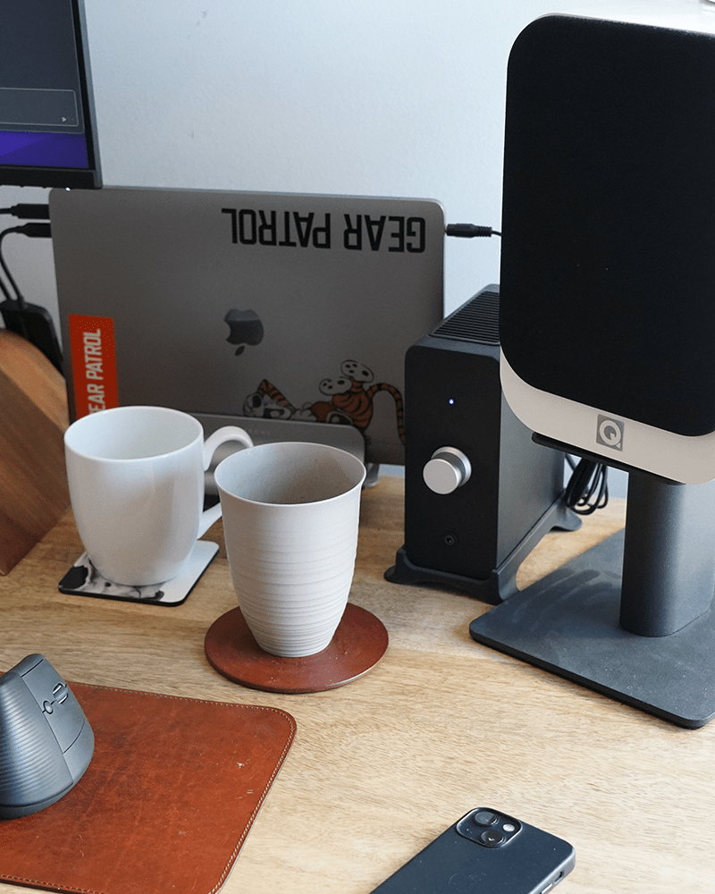 a desk close up featuring q acoustics 3020 bookshelf speakers