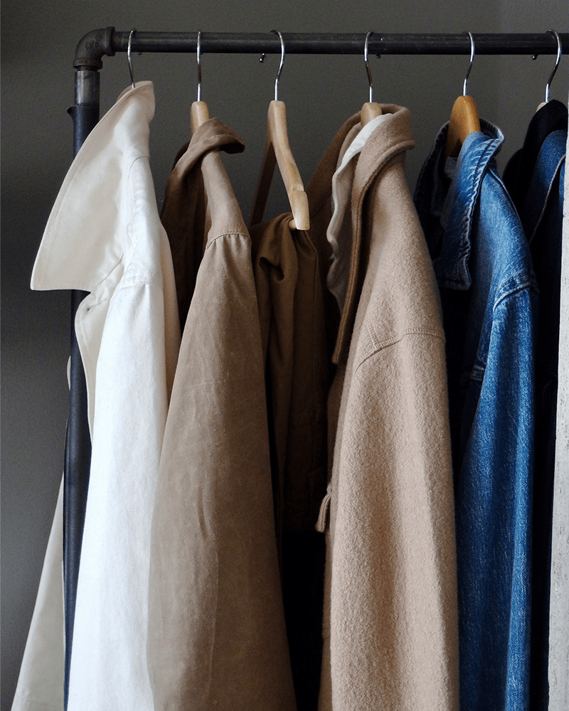 a clothing rack holding an assortment of different colored garments