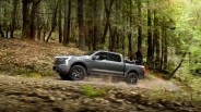 ford f 150 lightning driving in forest with a dirt bike in the bed