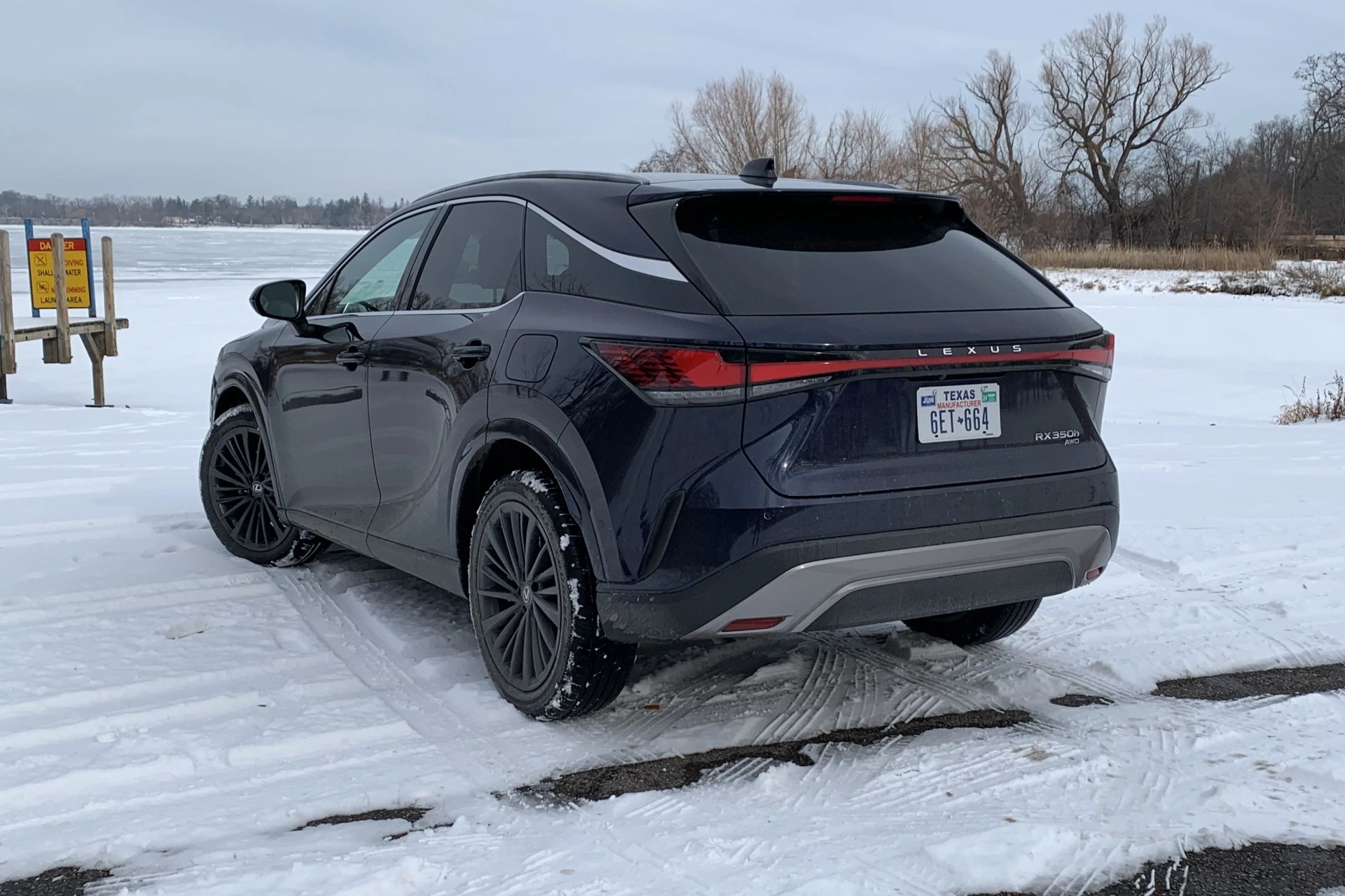 lexus rx 350h from the rear next to a snowy boat launch