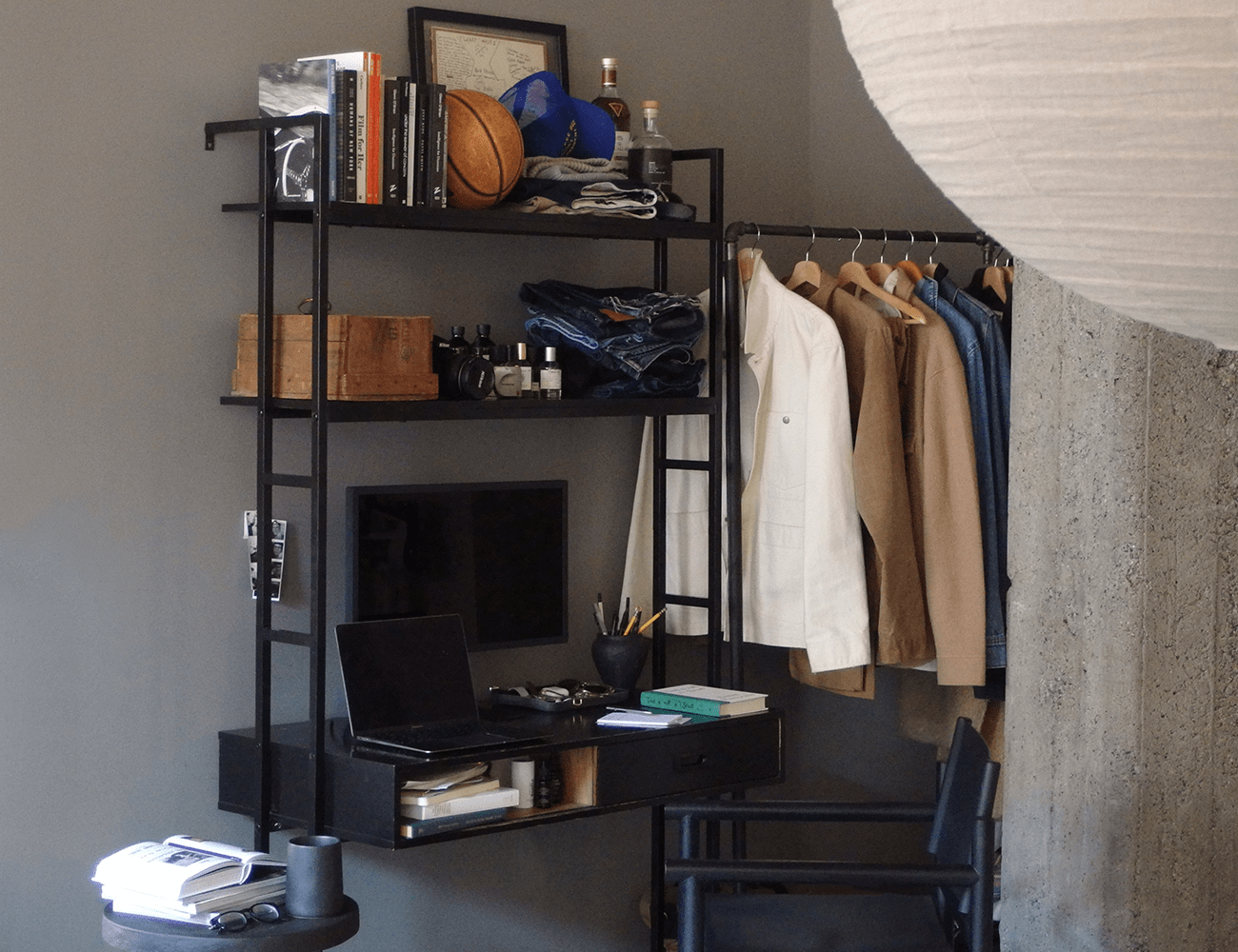 a full view of evans black desk in front of a grey wall