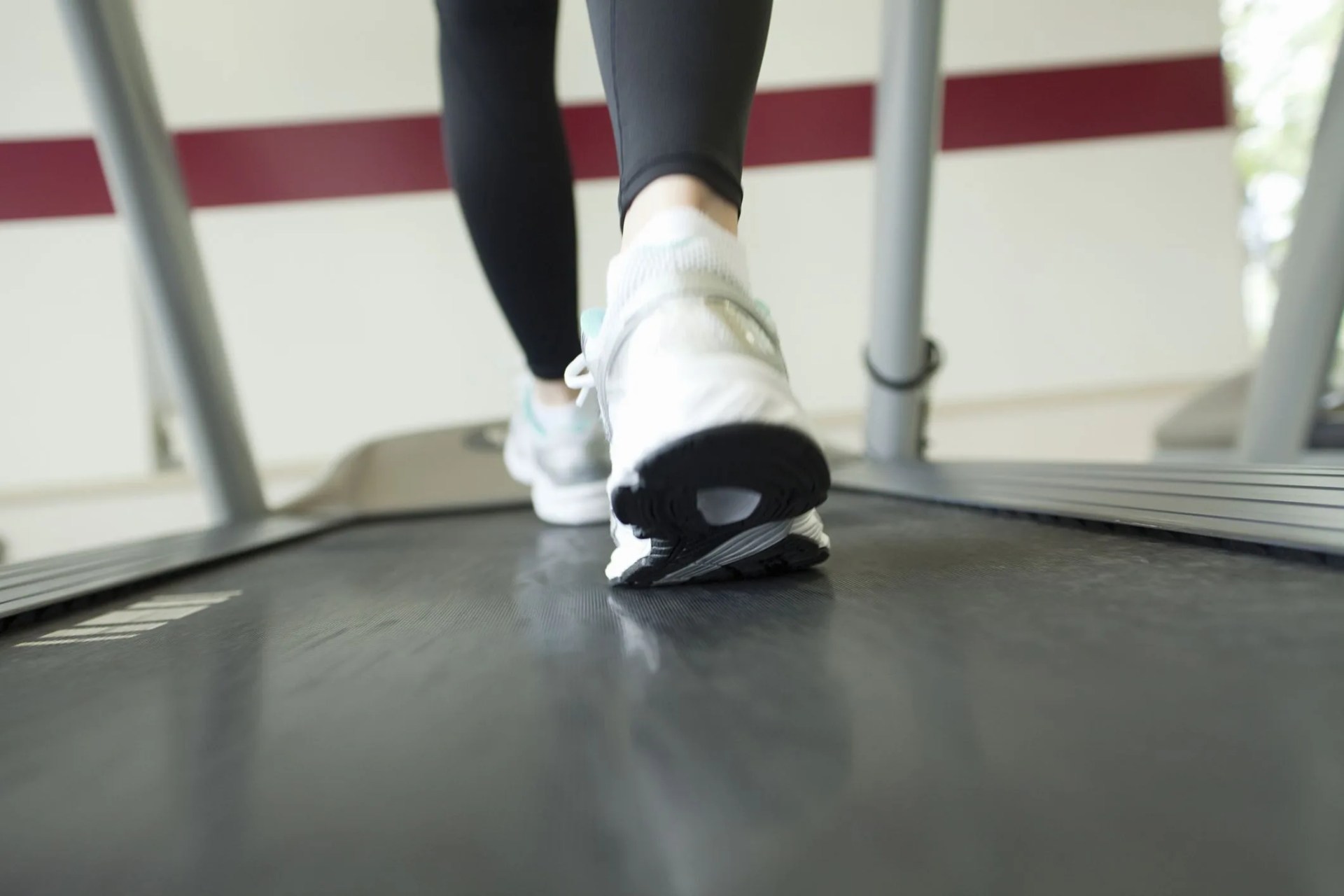low section of woman exercising on treadmill