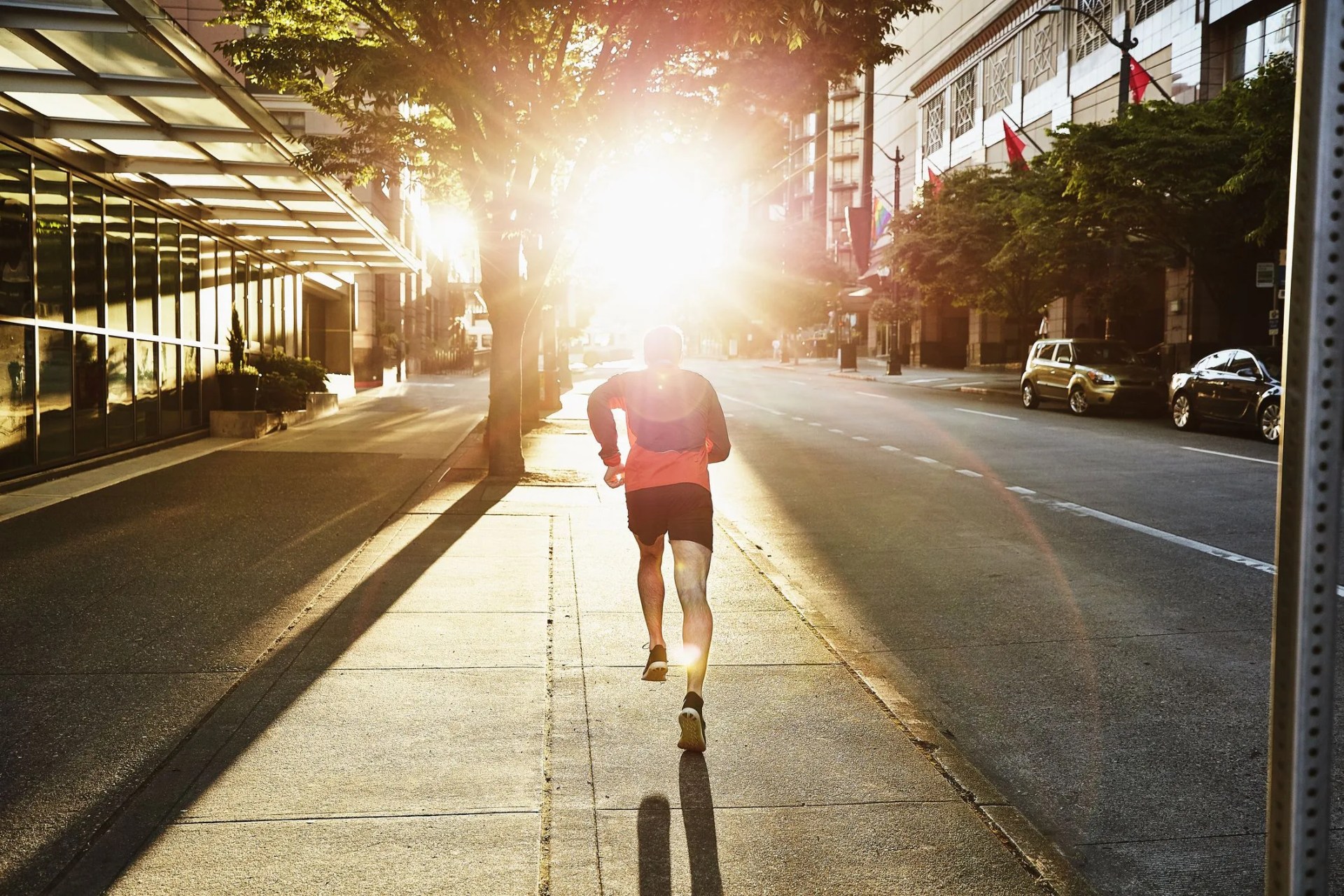 man on early morning run on empty city street