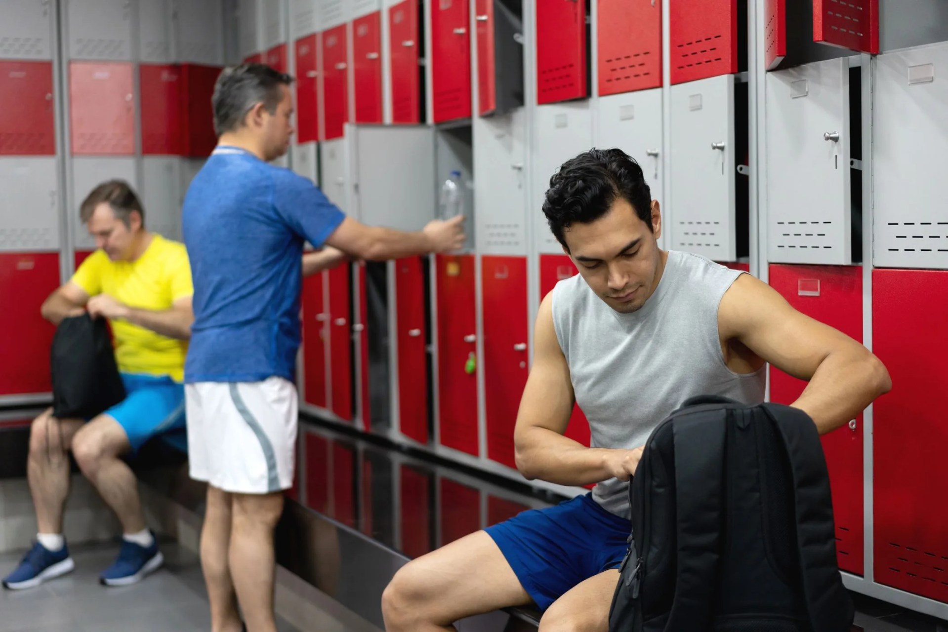 men getting ready to workout at the gym in the locker room