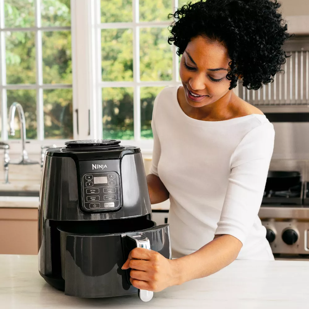 person opening air fryer