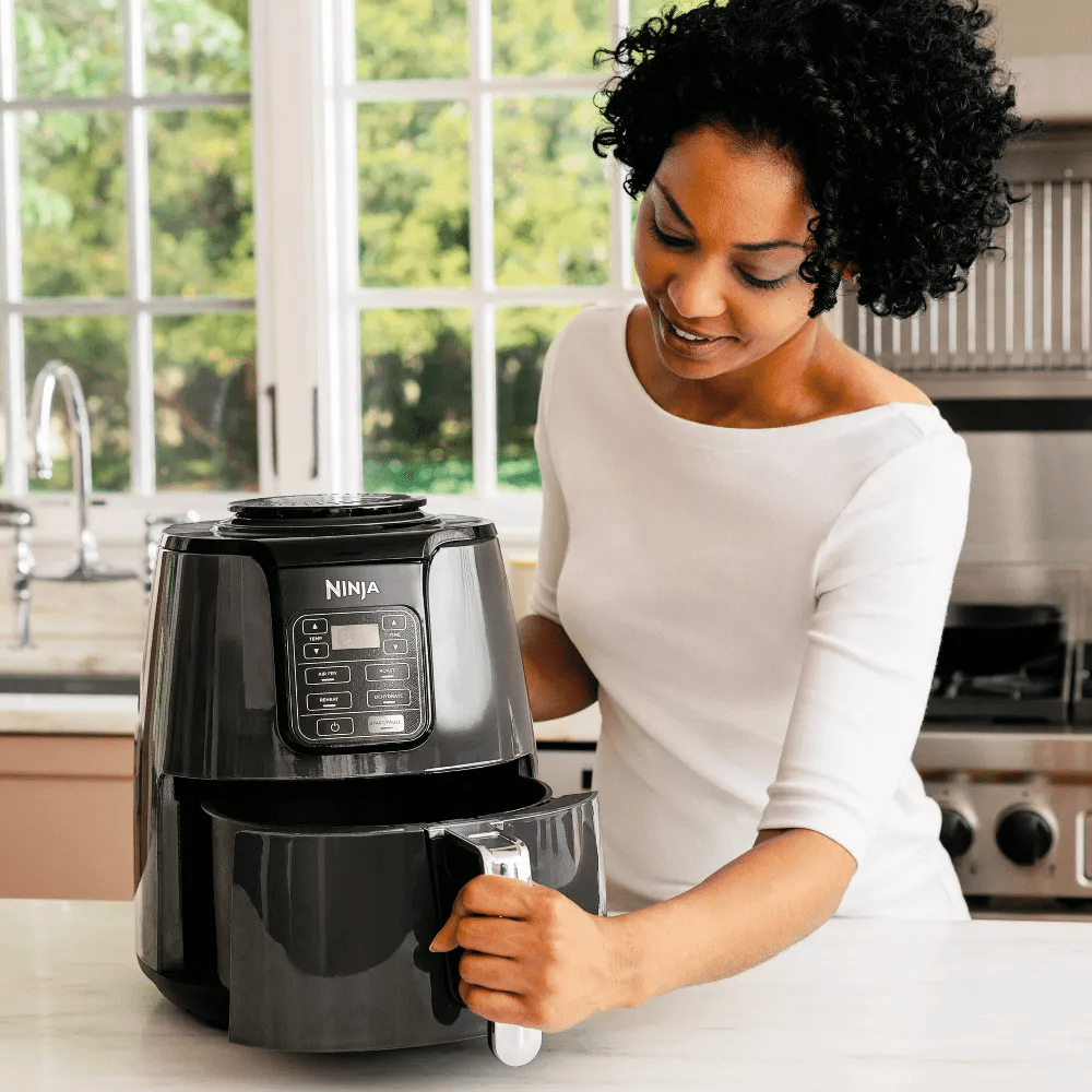 person opening air fryer
