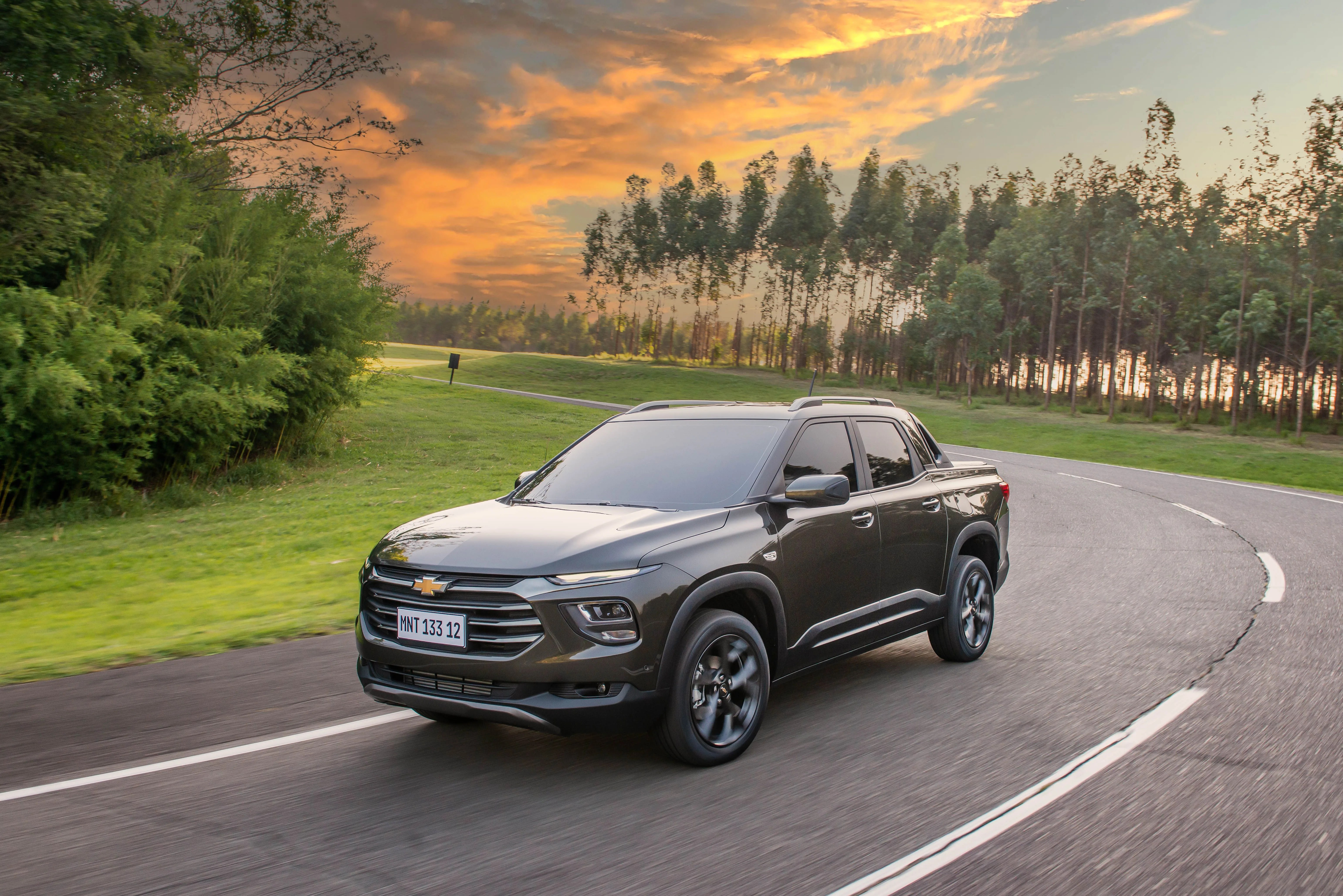chevrolet montana pickup truck rounding a corner on the street at sunset