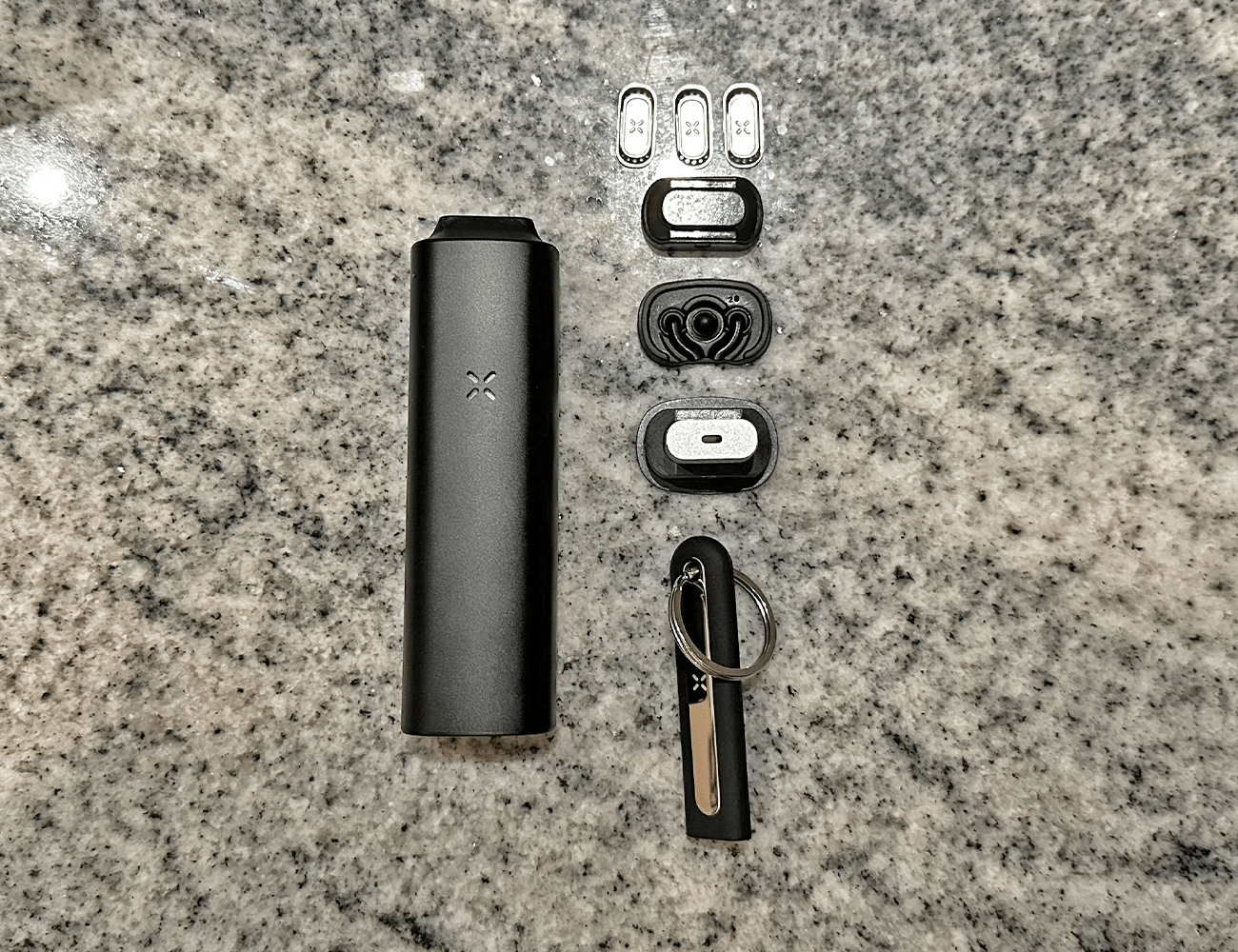 a pax plus laid on a marble countertop next to all of it's adaptable pieces