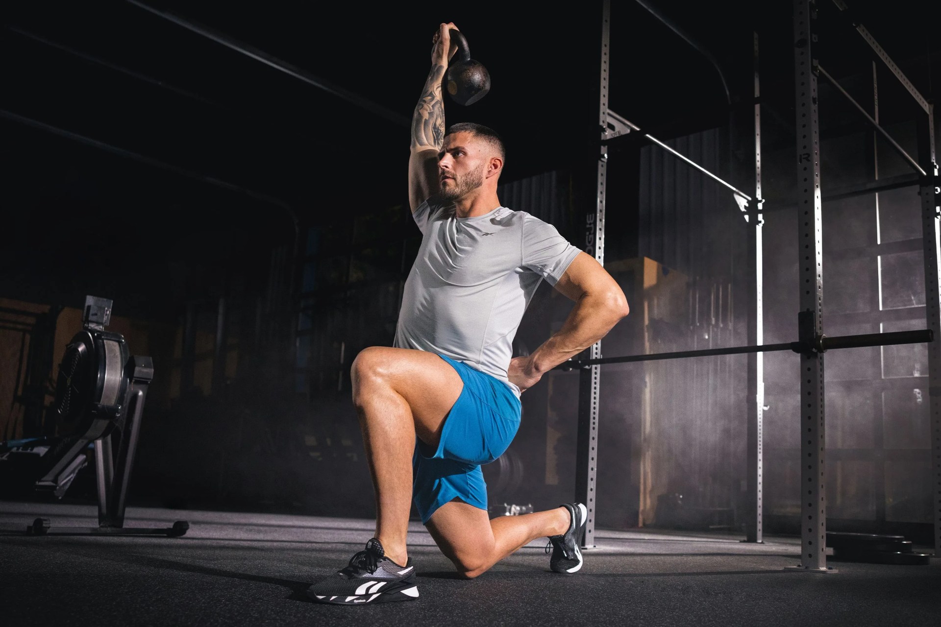 a man lifting a weight in a gym