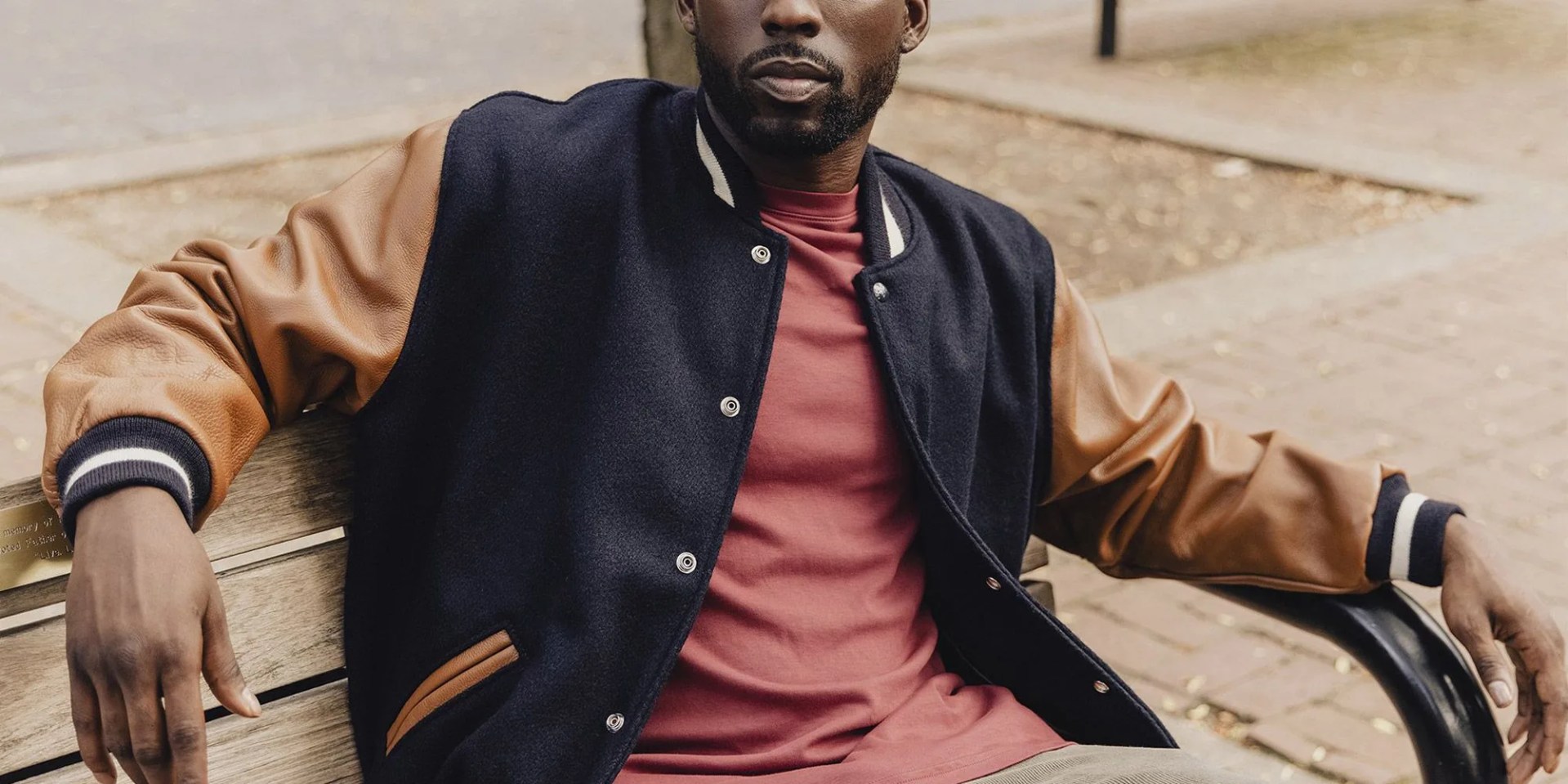 man wearing american trench varsity jacket