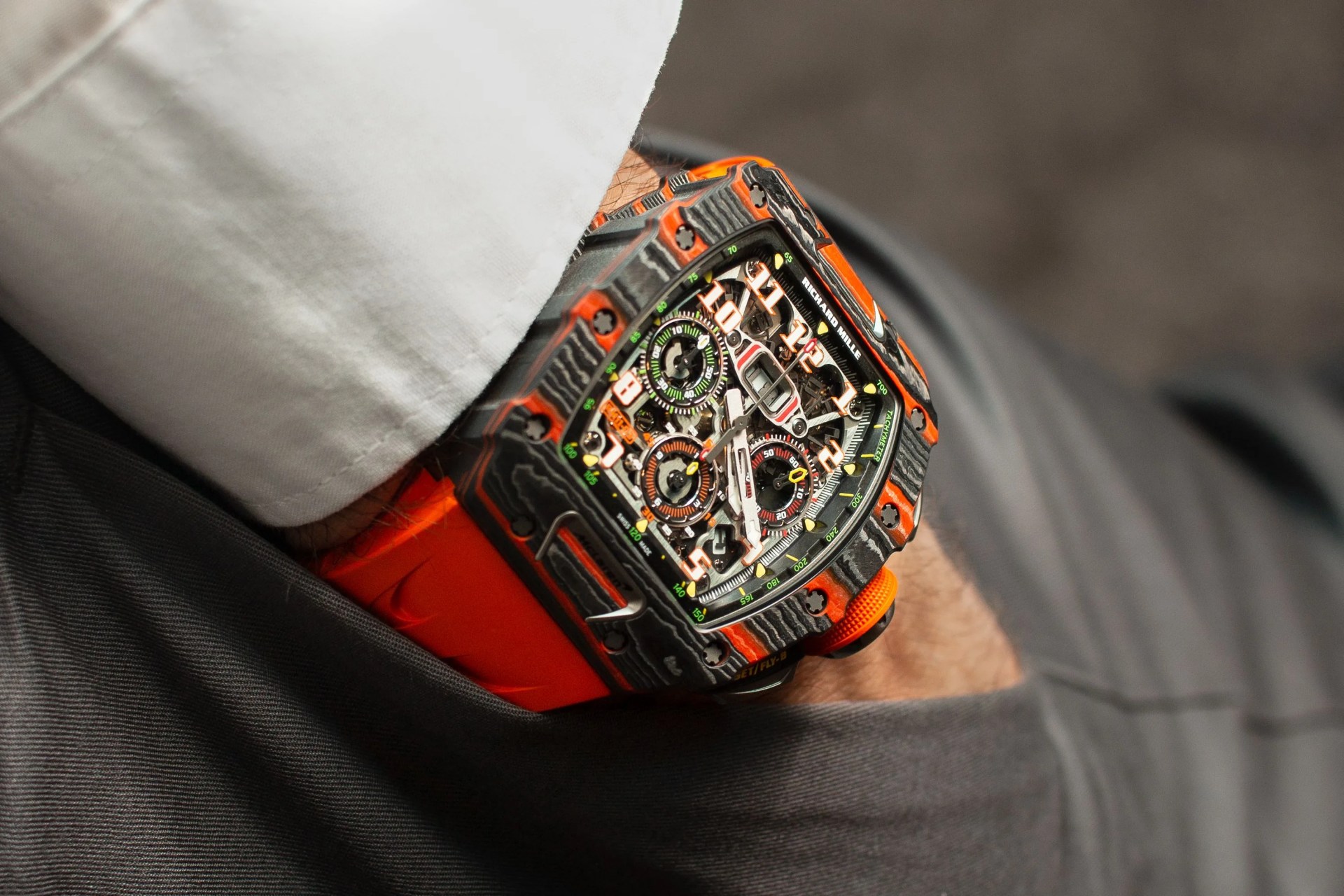 a hand in a pocket with a richard mille watch on the wrist