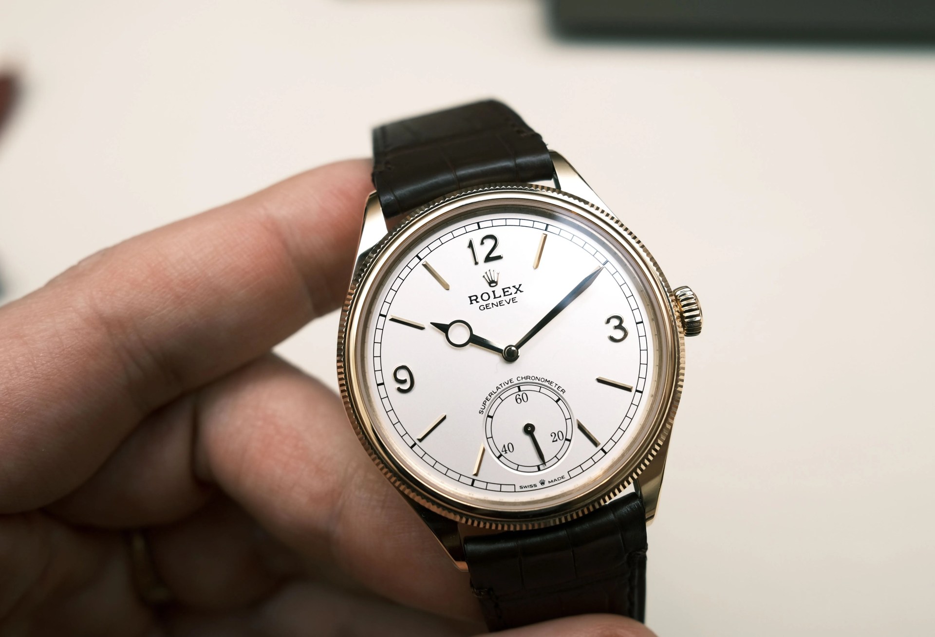rolex dress watch held in hand