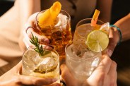 four people cheersing cocktail glasses