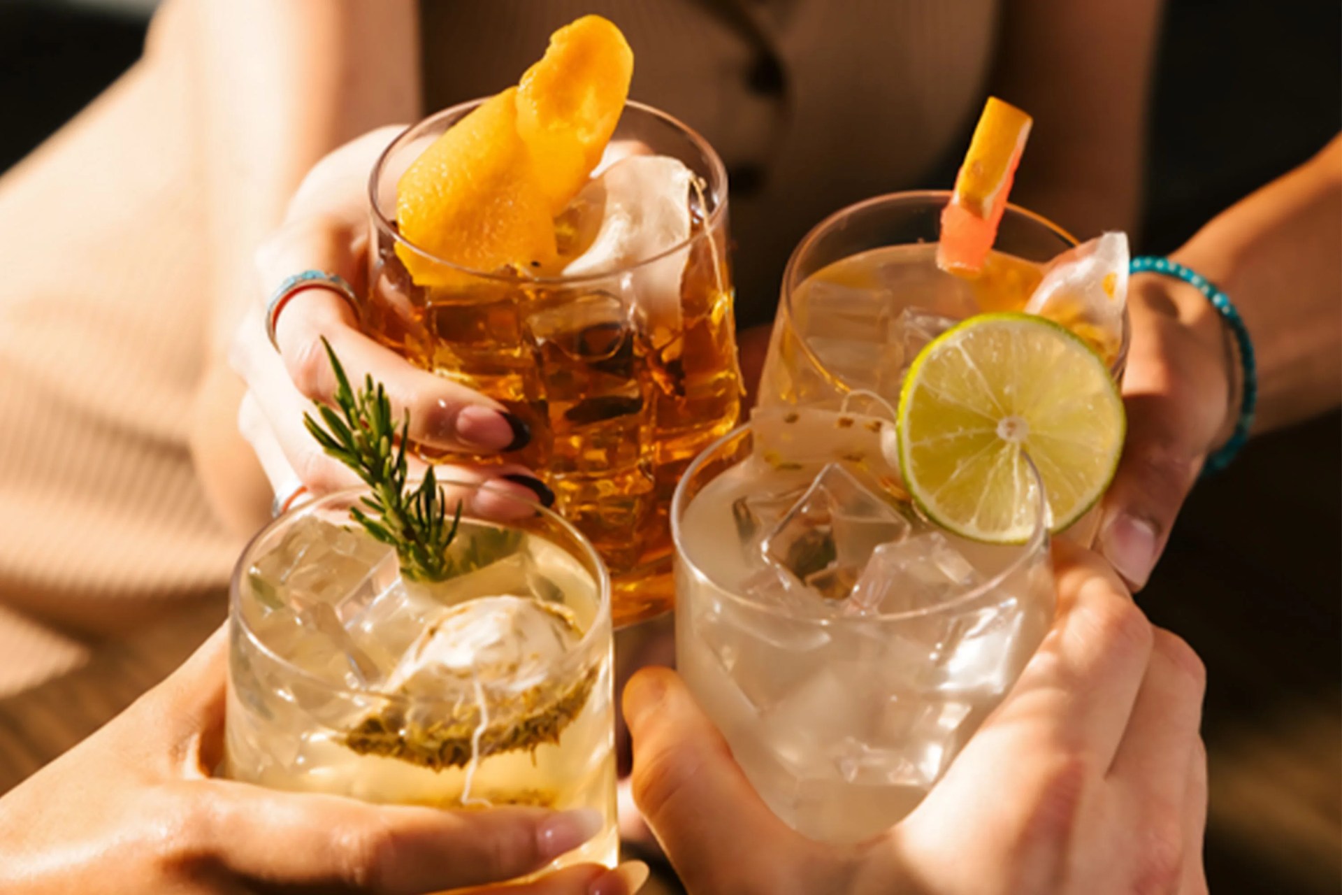four people cheersing cocktail glasses