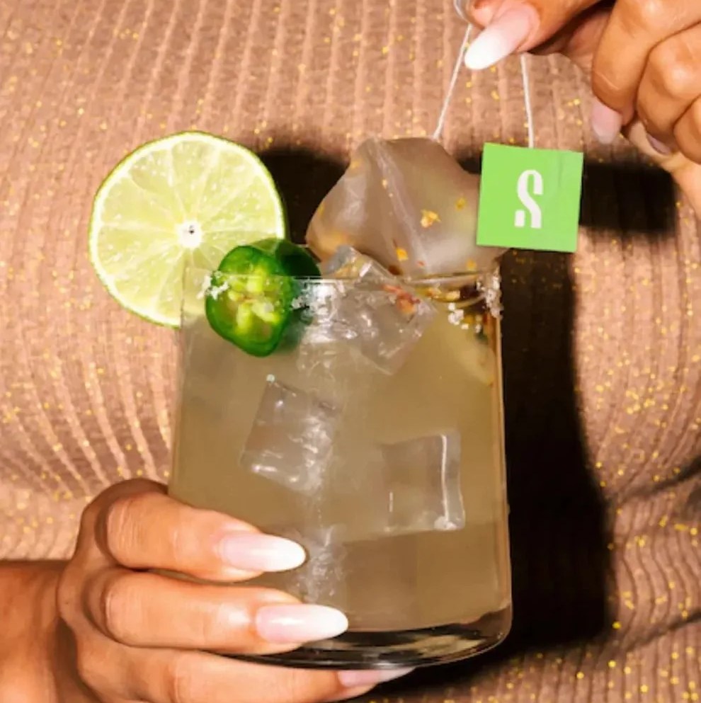 a woman holding a skinny margarita