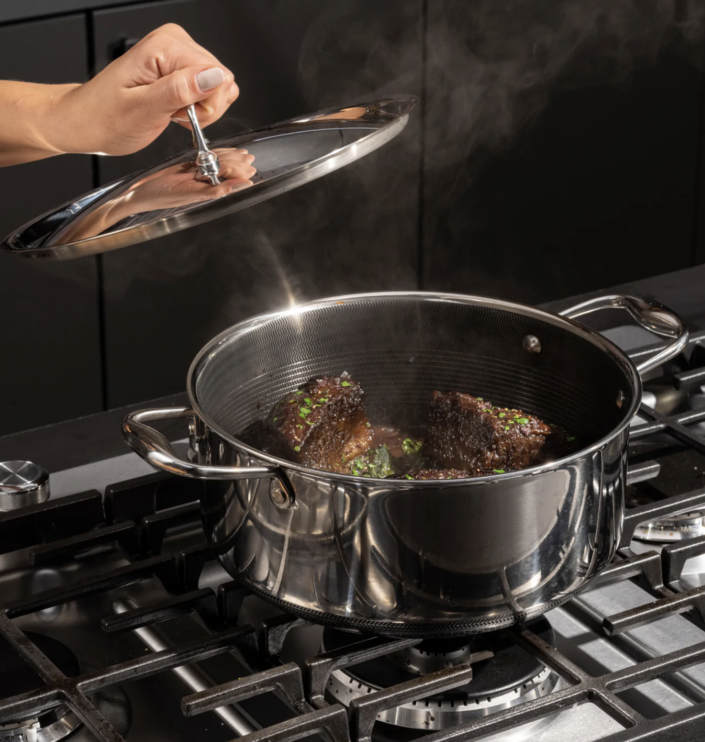 dutch oven on stove with meat in it