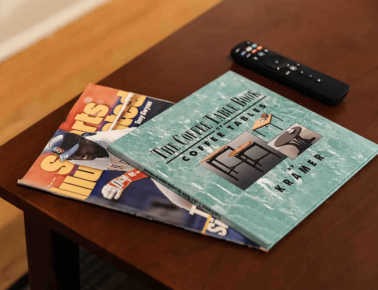a coffee table with a vintage sport illustrated and a vintage book about coffee tables on it