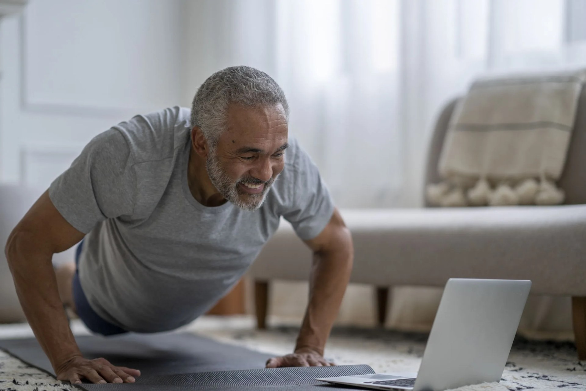 senior gentleman exercising virtually at home
