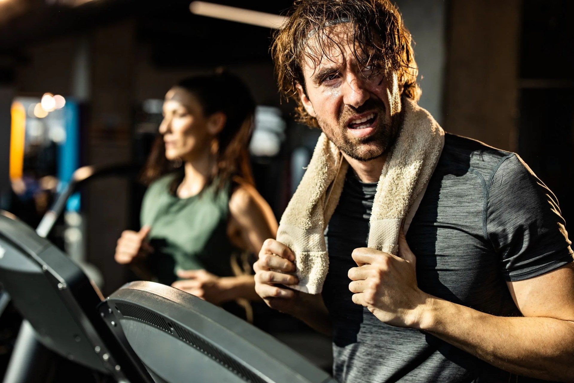 sweaty athletic man feeling tired on sports training in a gym