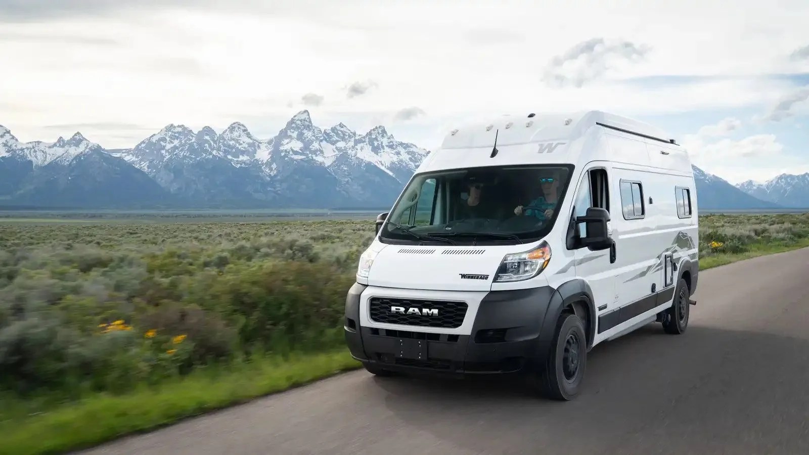 winnebago solis npf camper van driving with mountains in the background
