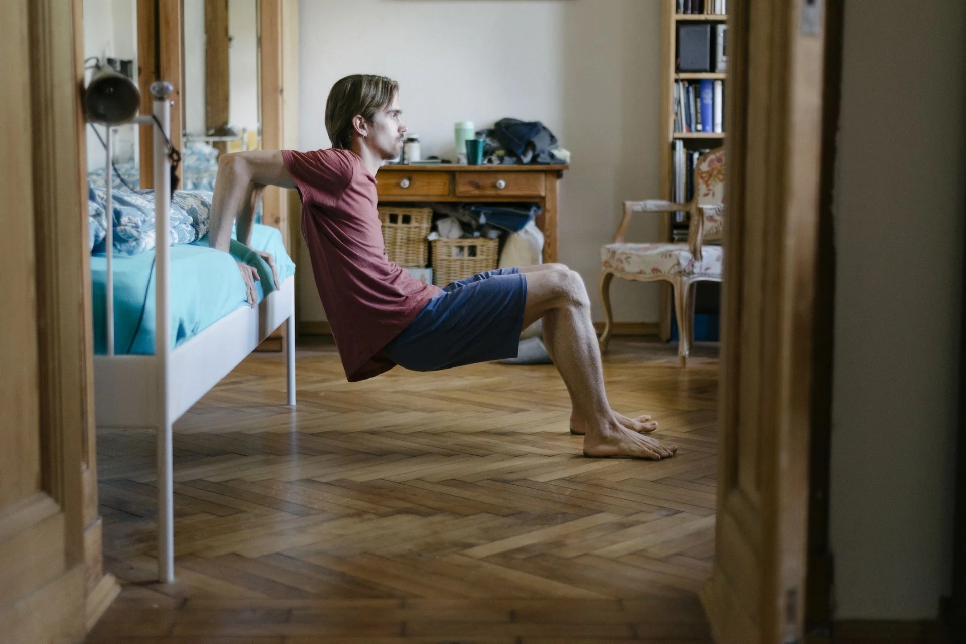 young man doing body weight exercises at home
