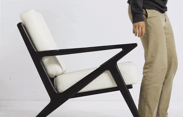 a man sitting in a wooden z lounge chair