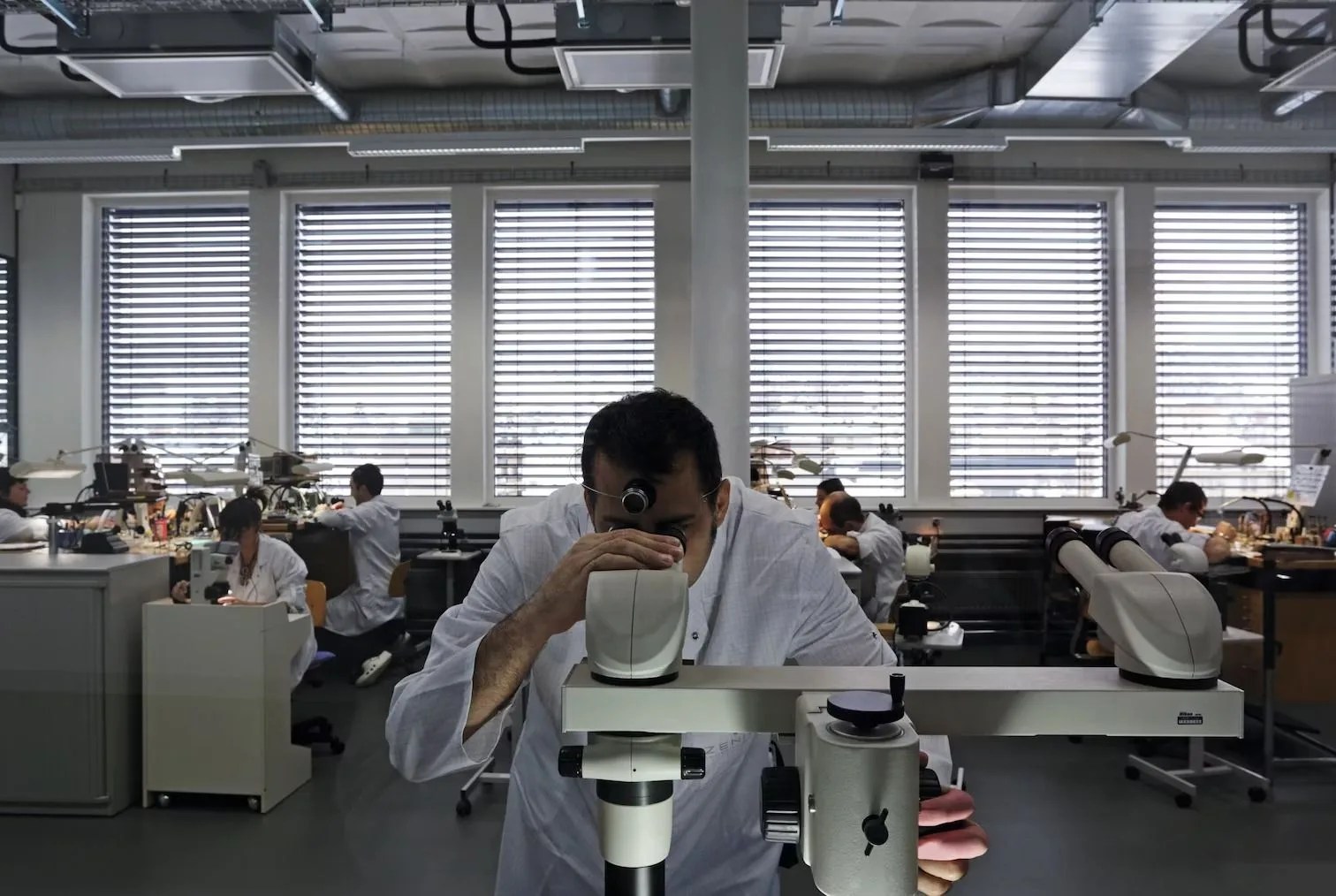 people watch making at the zenith watch factory