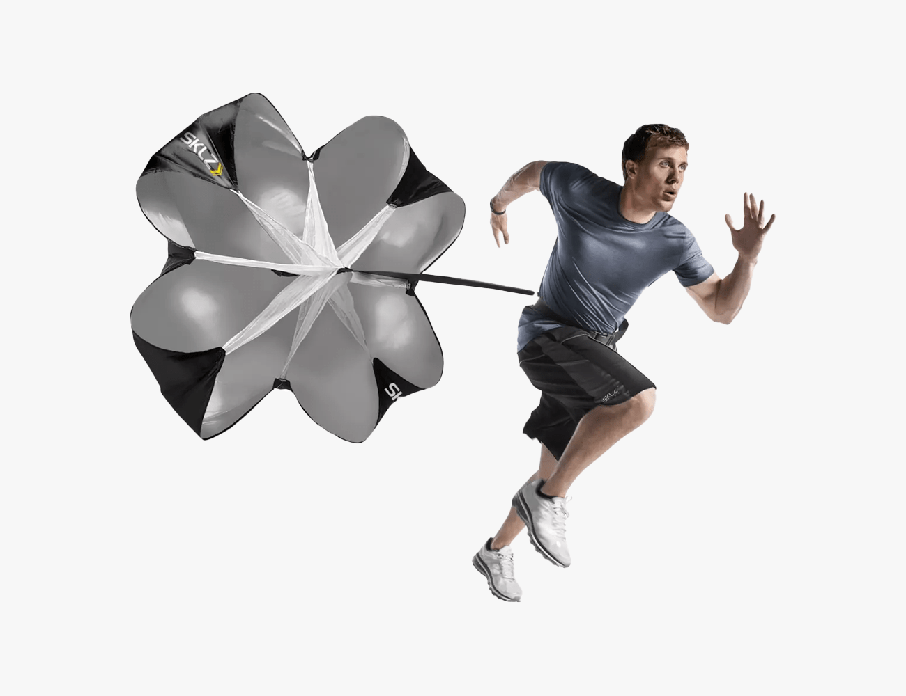 a man running with a black and white SKLZ Speed Chute behind him
