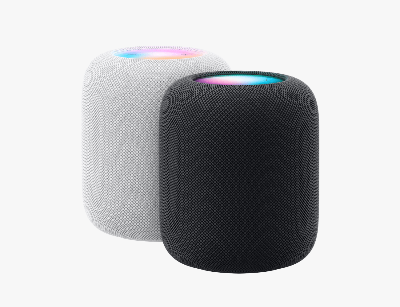 two apple homepods one in white and one in black
