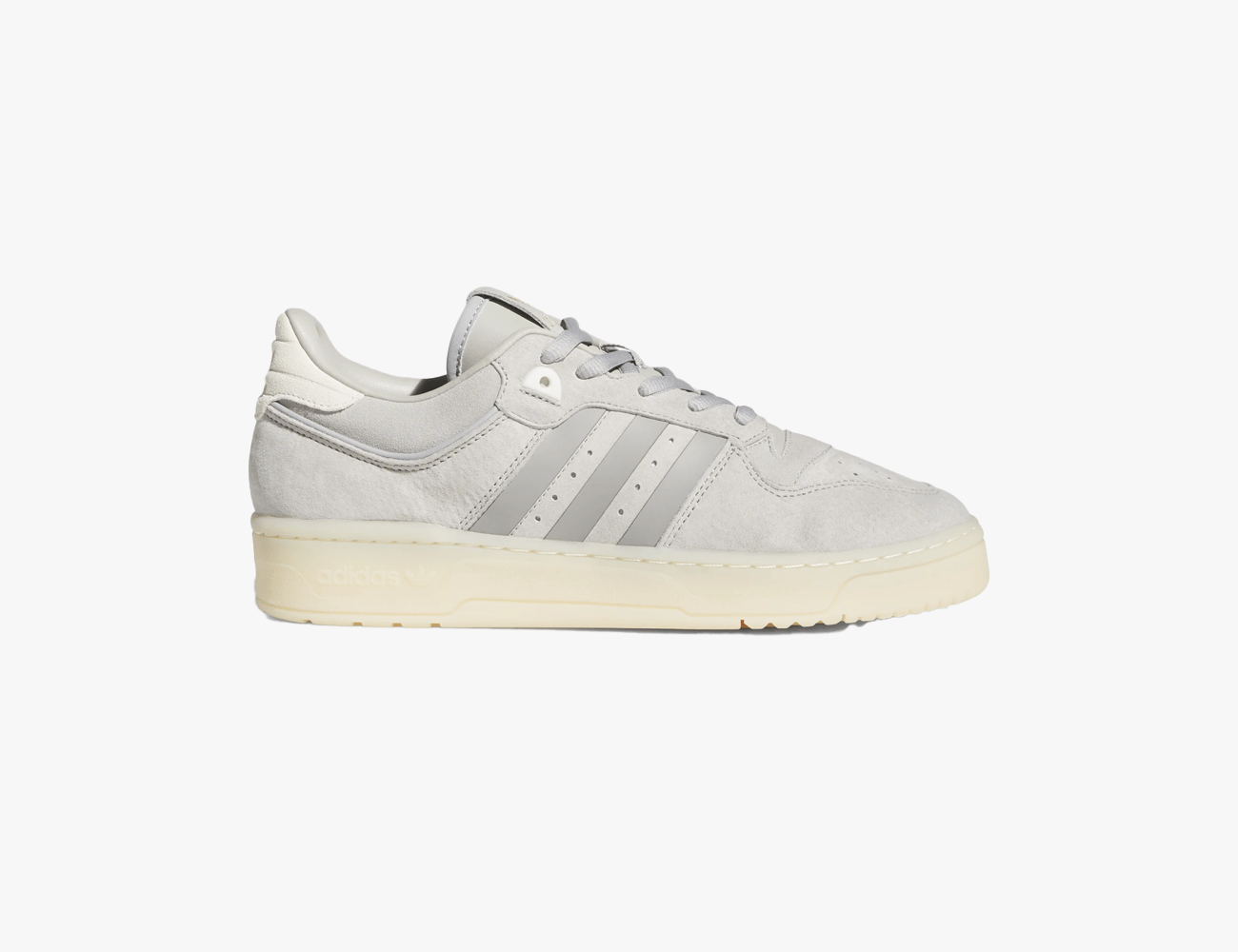 a grey adidas low top show with cream sole