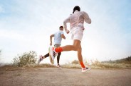 two people running on a dirt trail