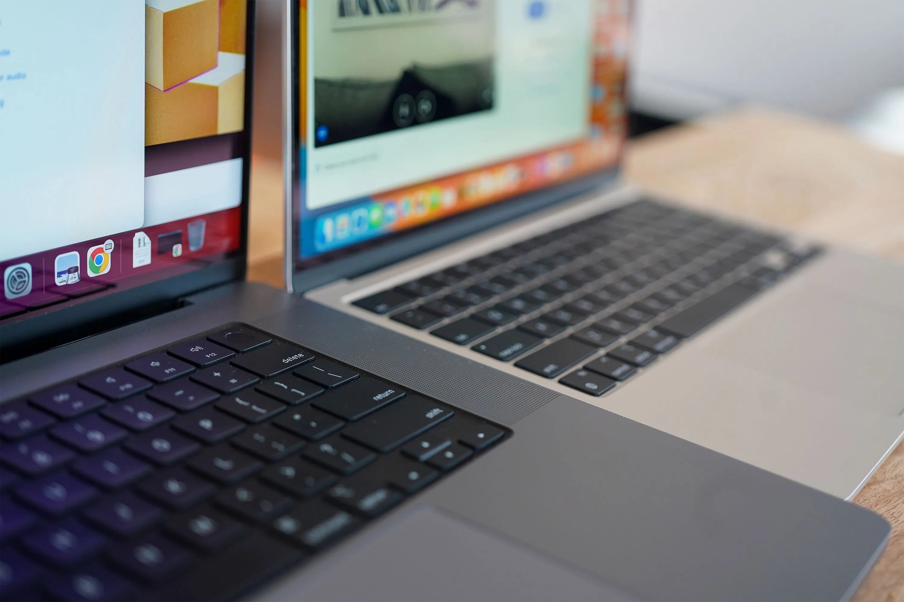 two apple macbooks on a table