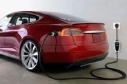 a red car being charged with a portable ev charger