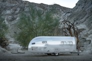bowlus heritage edition trailer parked in mountains next to a dead tree