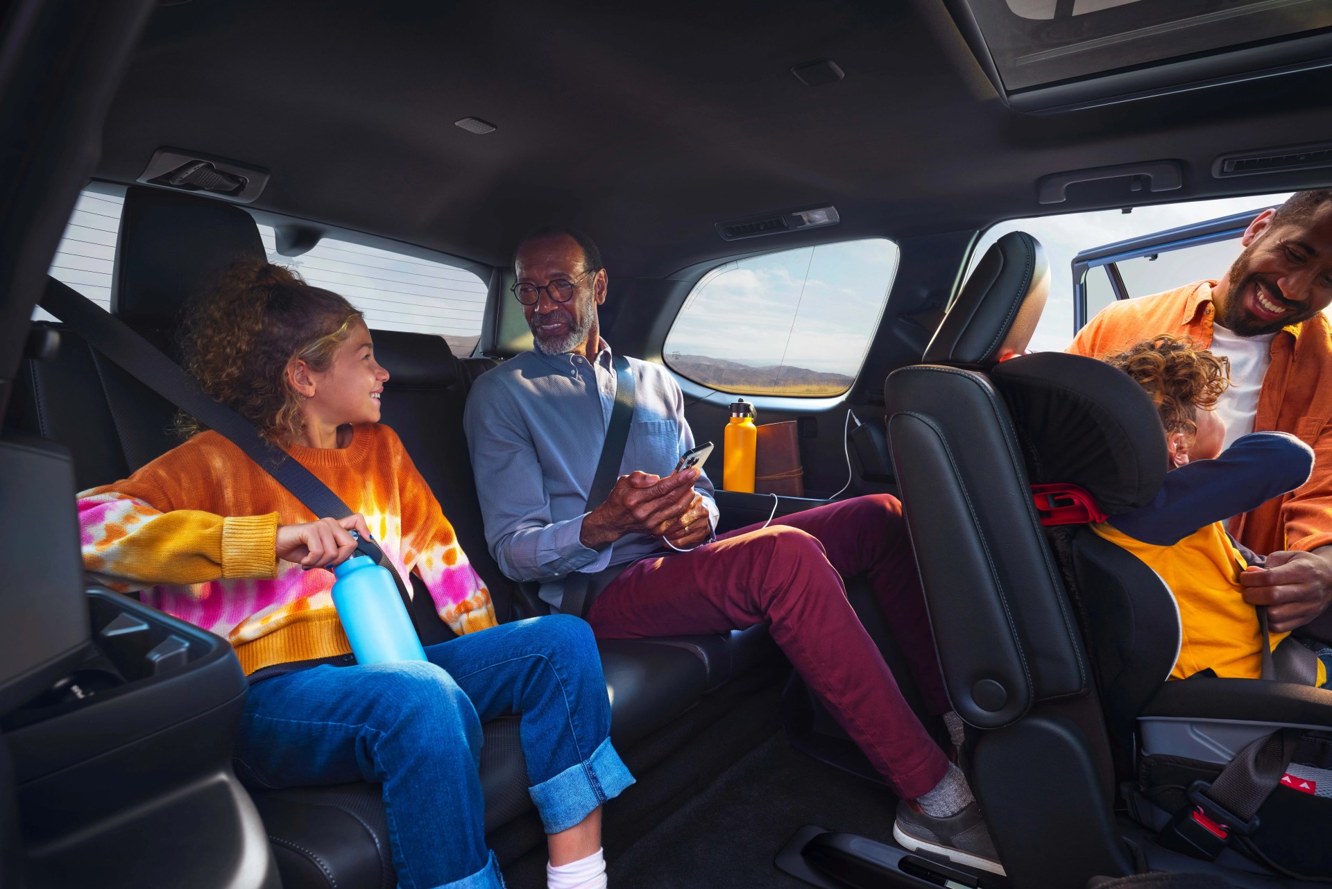 toyota grand highlander interior teaser with grandfather and grandaughter sitting in a spacious third row